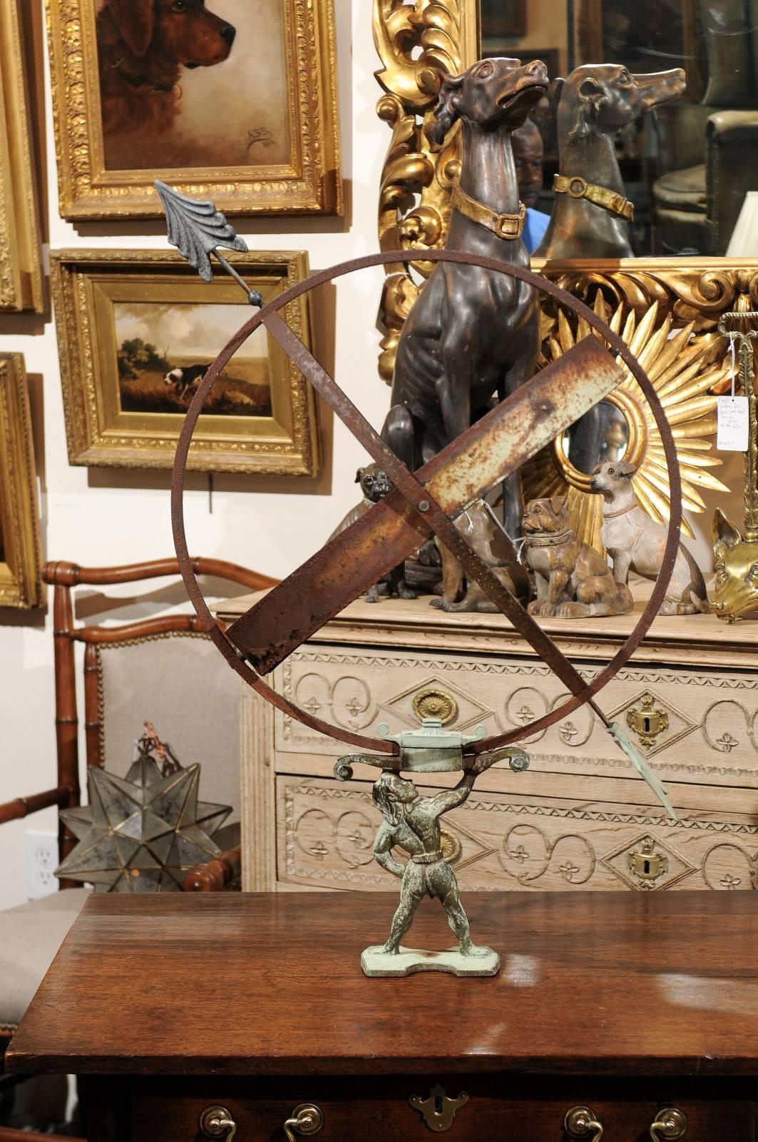 A Swedish copper armillary depicting Atlas carrying the world from the early 20th century. The famed Titan Atlas was condemned to carry the sky on his shoulders for eternity. How appropriate then, to choose him to carry, effortlessly this armillary!