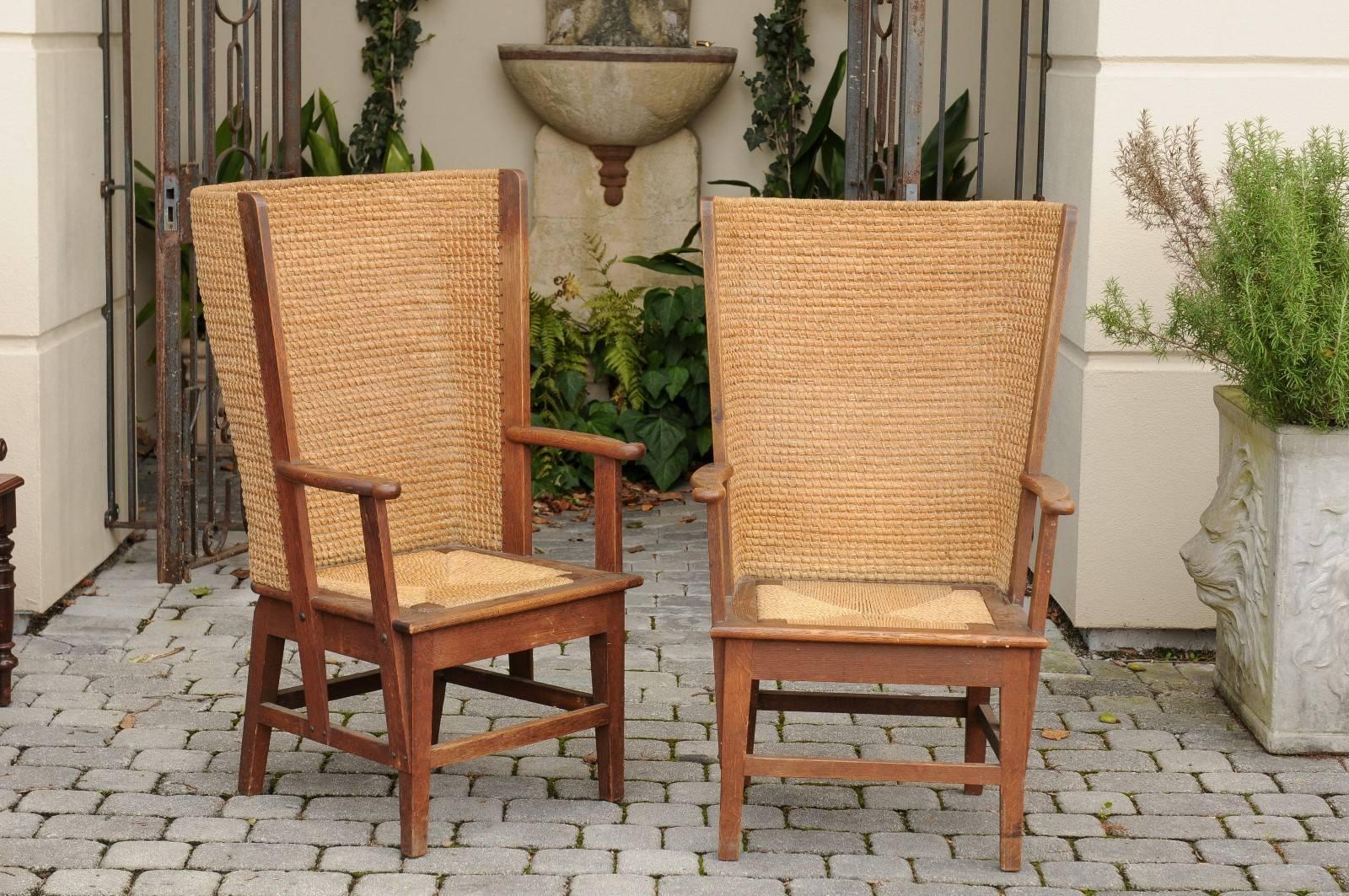 A pair of Scottish Orkney armchairs from the turn of the century. This pair of oak and straw armchairs, circa 1900 was born in the Orkney Islands near the northern tip of Scotland. Produced in the late 19th, early 20th century, these stylistically