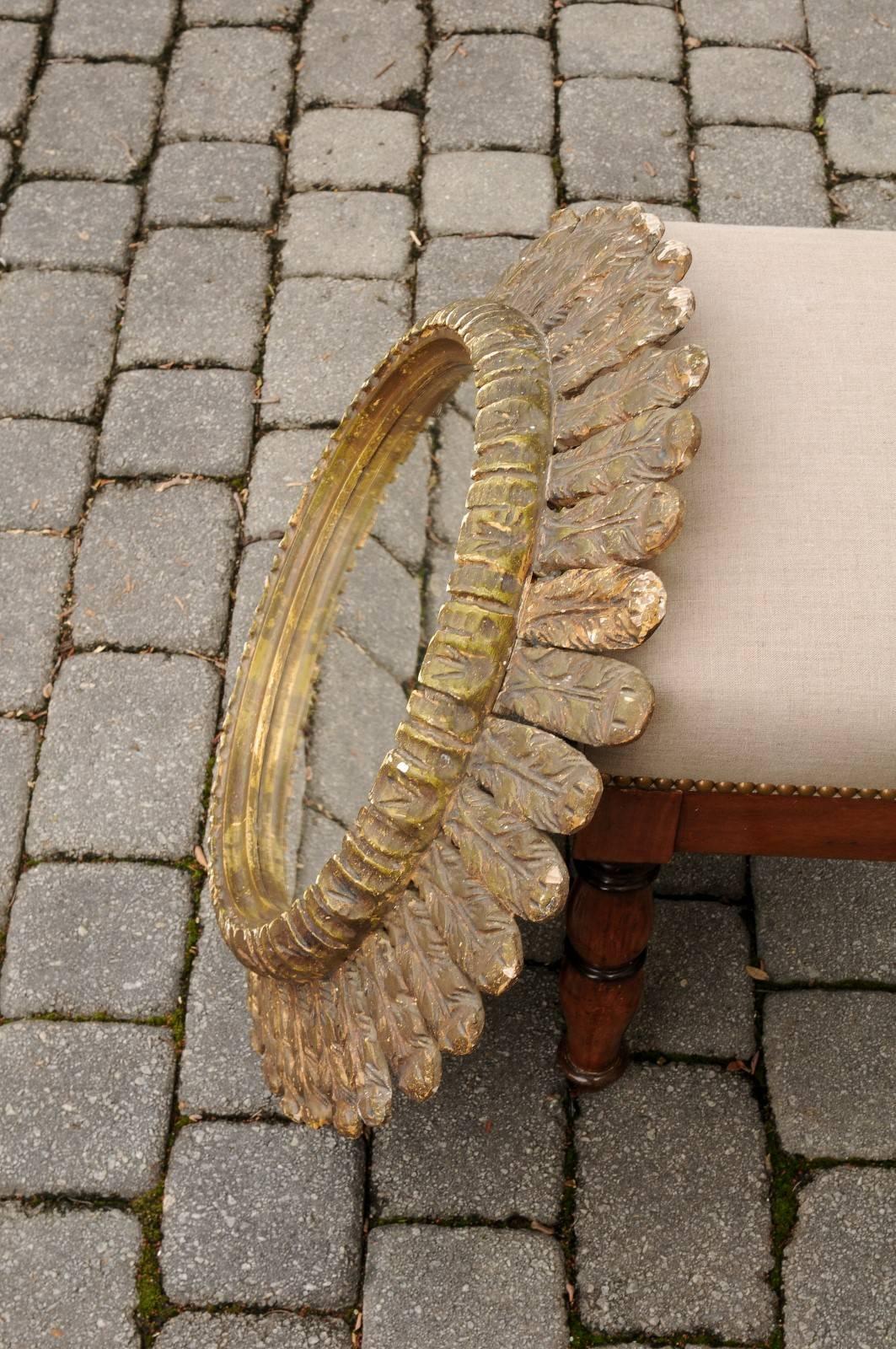 Mid-Century Modern Italian Carved Giltwood Circular Mirror with Foliage Motifs from the 1950s