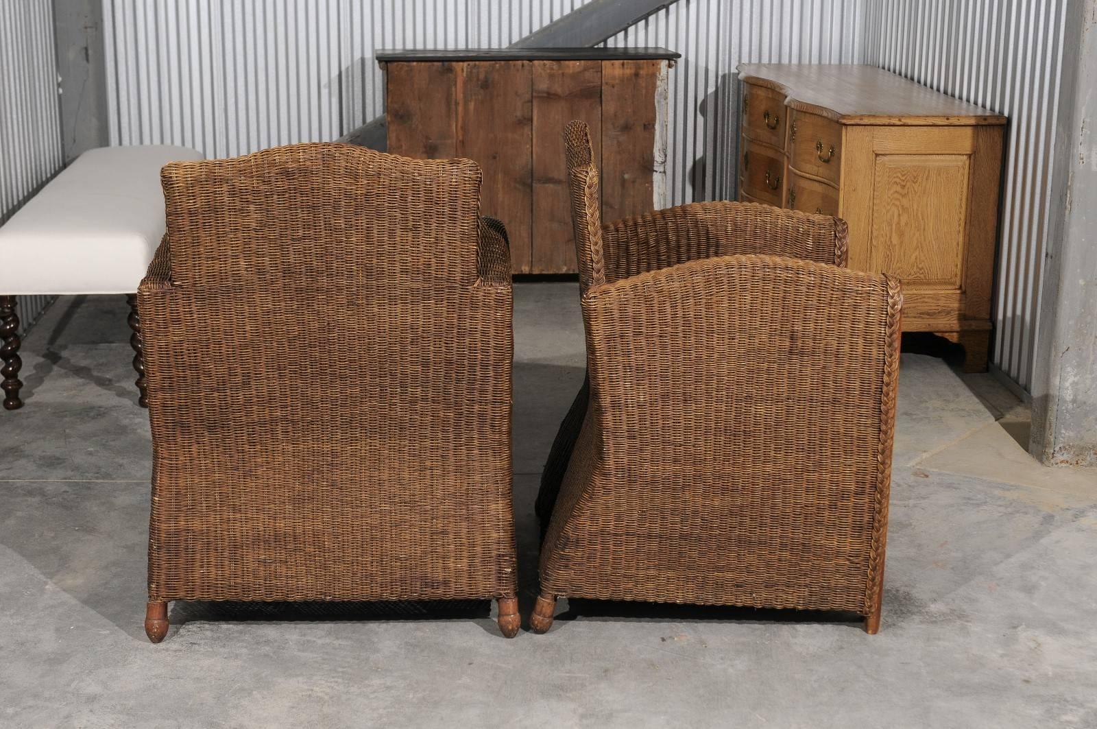 Pair of French Vintage Wicker Club Chairs with Camel Back and Tall Arms For Sale 1