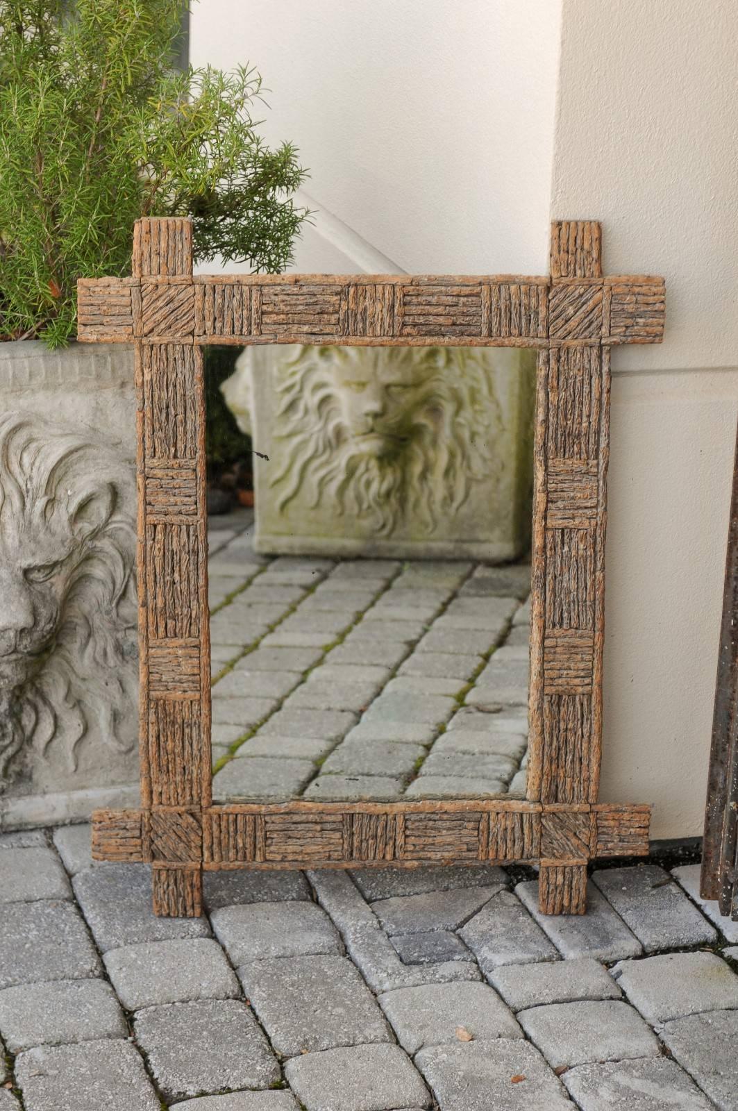 A French rectangular bark mirror from the early 20th century. This French mirror was born in the 1920s (the Années Folles in France) during the vibrant Art Deco period, famous for its research on geometric forms. This mirror features a simple