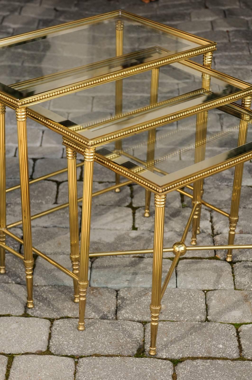 Mid-Century Modern Set of Three 1950s French Brass and Glass Nesting Tables with Beaded Trim For Sale