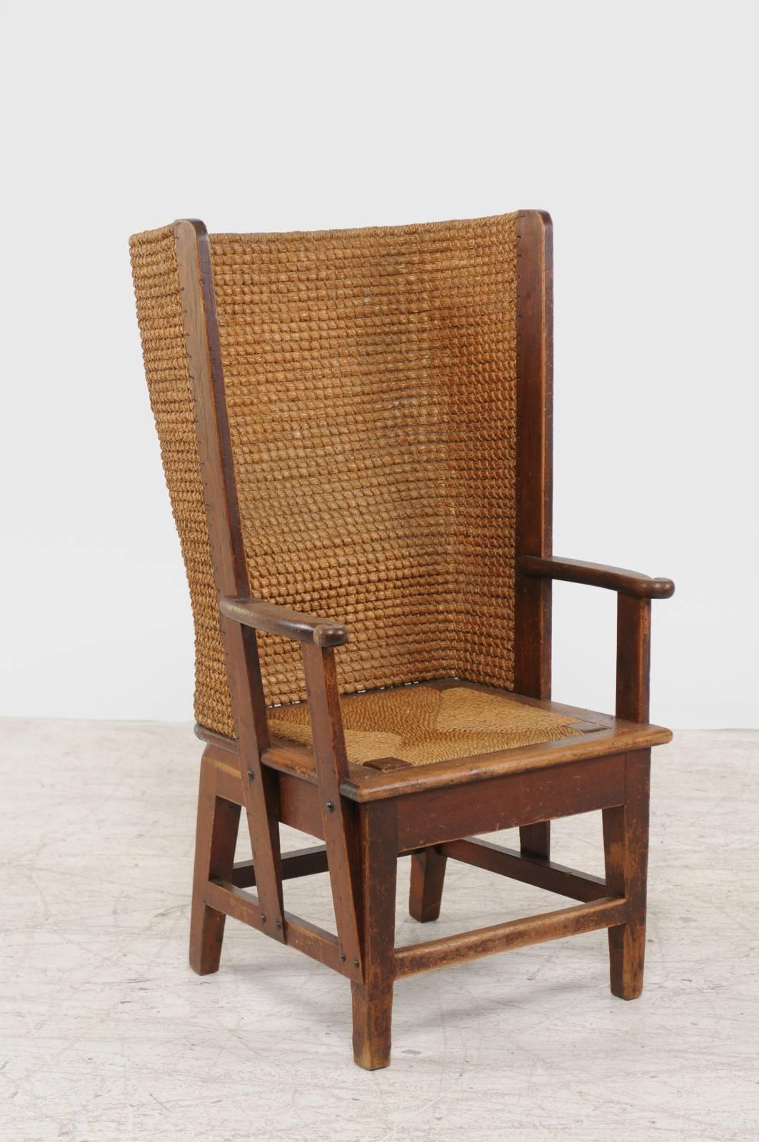 A Scottish orkney chair with handwoven wrap around straw back, wooden arm supports, straight legs and side stretchers from the late 19th century. This wood and straw chair was born in the Orkney Islands near the northern tip of Scotland during the
