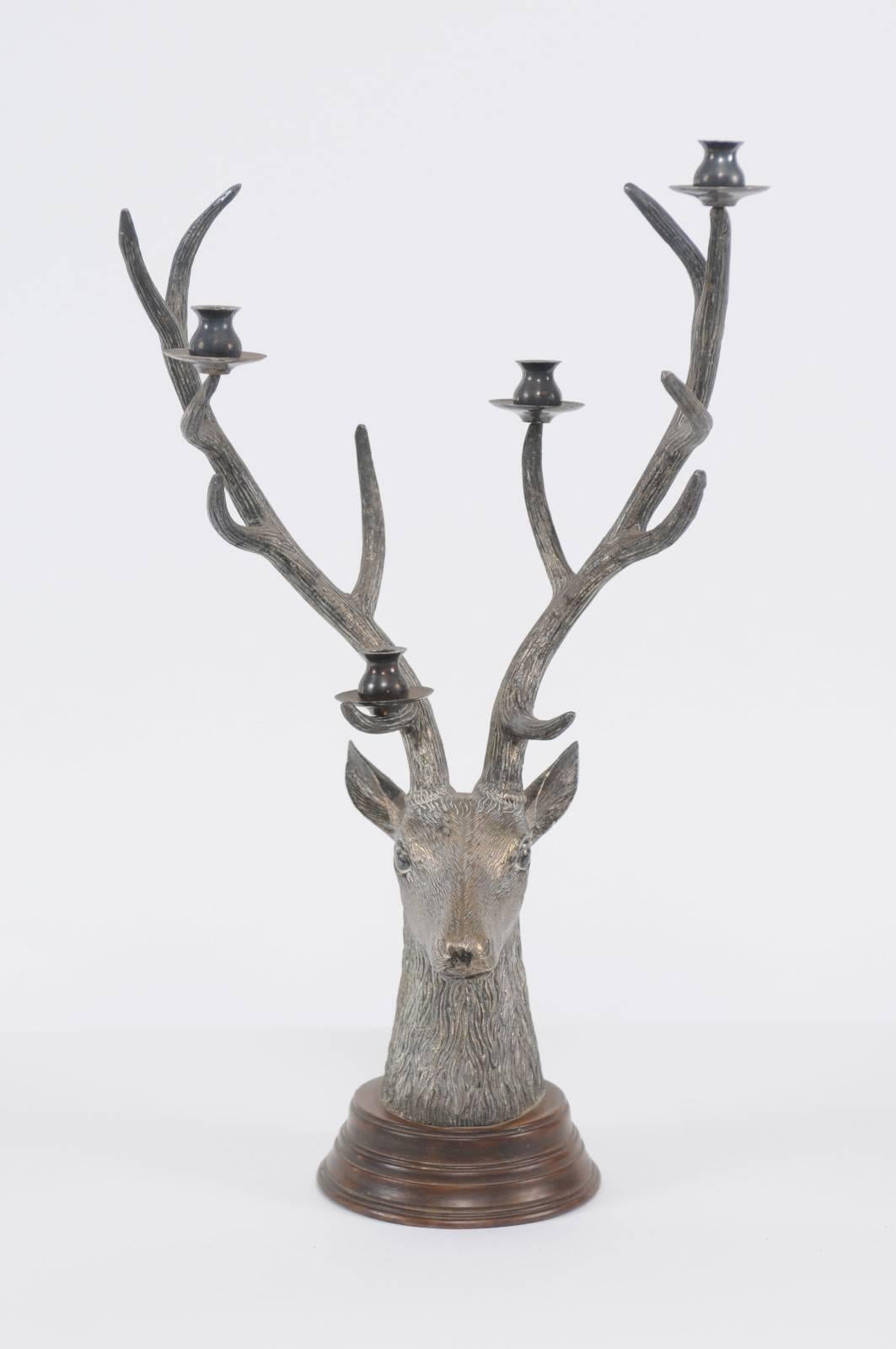 A vintage French bronze buck head candelabra sculpture mounted on a wooden circular base from the mid-20th century. This unusual cast bronze candelabra features an exquisite buck head, depicted in a quite realistic manner. Its tall antlers, giving