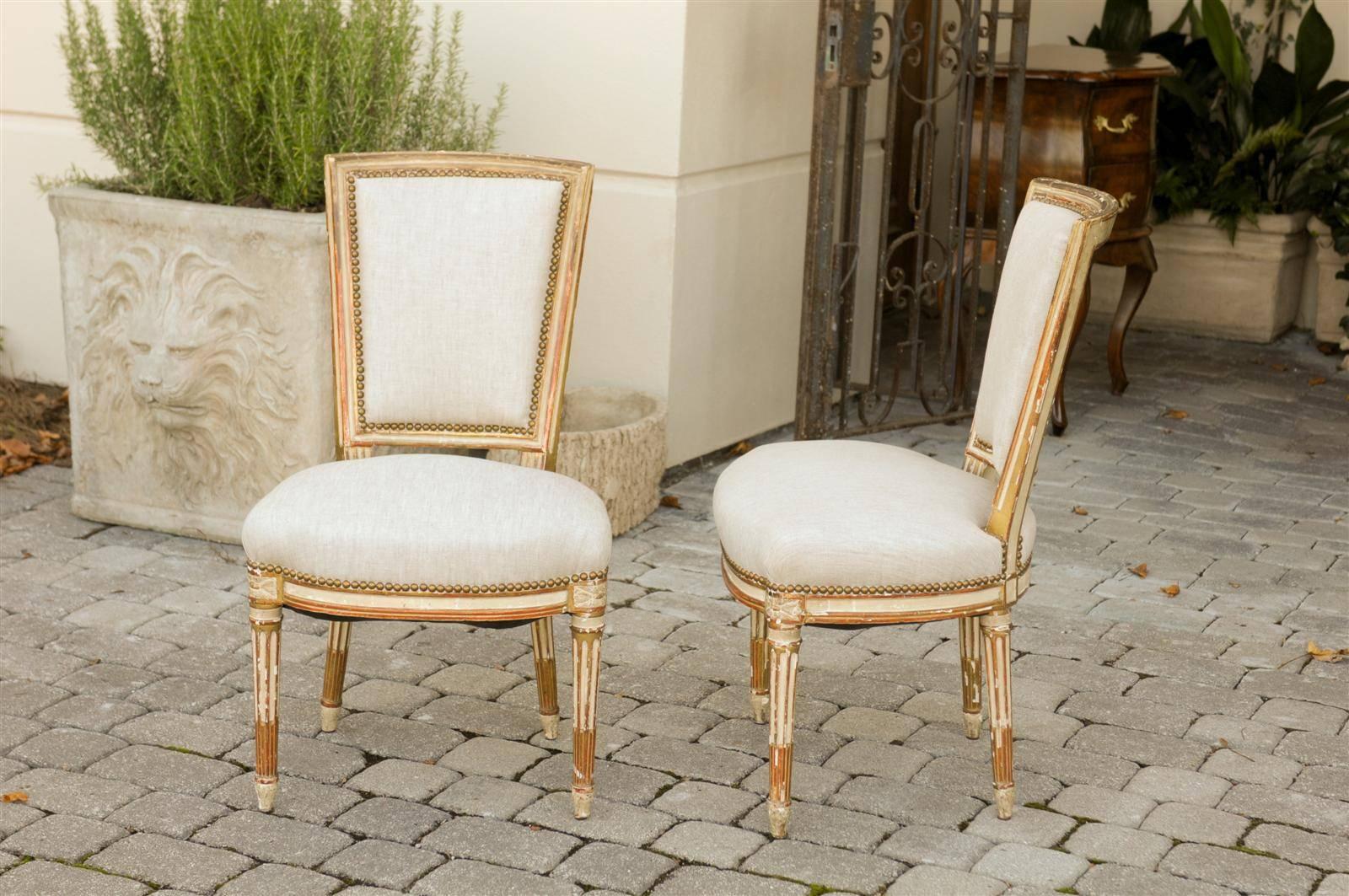 Wood Pair of French Louis XVI Style Painted and Gilded Upholstered Side Chairs, 1860s
