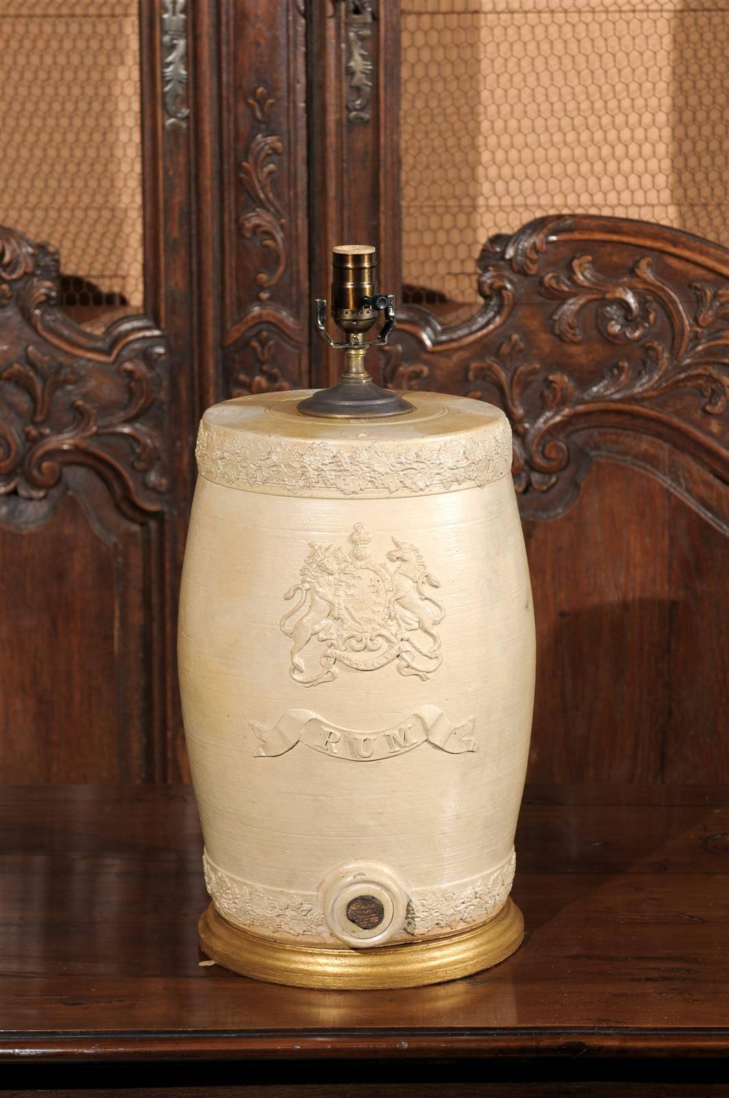 An English 19th century stoneware spirit barrel table lamp. This English stoneware spirit barrel from the mid-19th century has been converted into an exquisite table lamp. The glazed body is decorated with low-reliefs, depicting floral motifs and