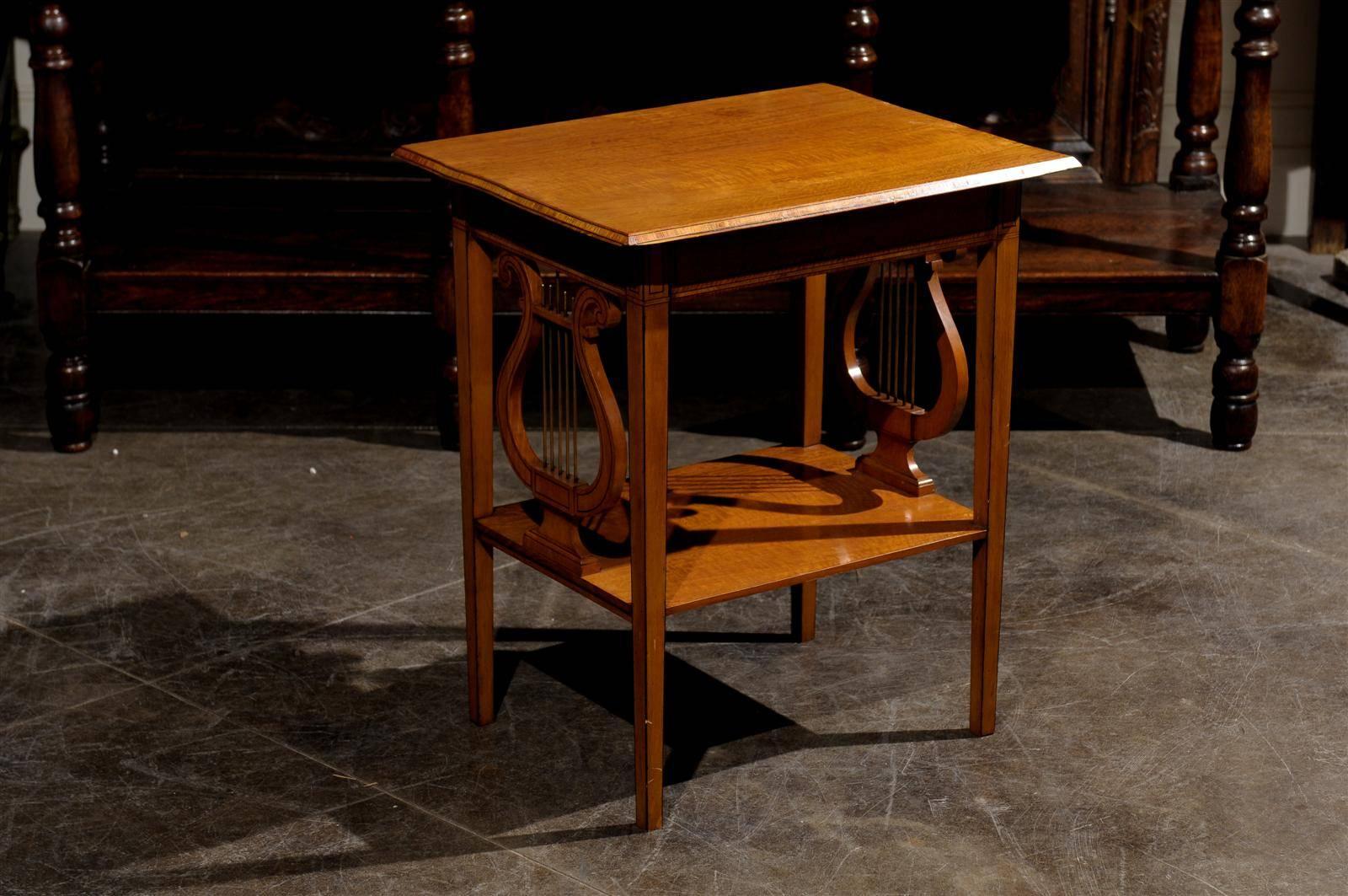A petite late 19th century English satinwood accent table from English firm Collinson and Lock. This petite English side table from circa 1890 is made of satinwood and features a rectangular top over four slightly tapered and straight legs, as well