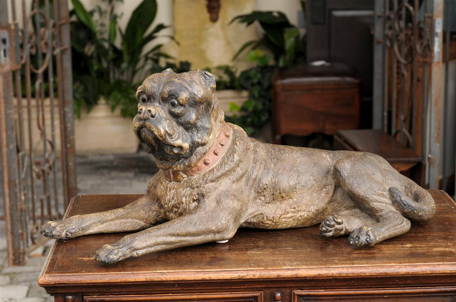 This large Austrian sculpture from the late 19th century features a terracotta dog. The dog is lying, but his attention focused on someone or something. He’s nonetheless relaxed as he strikes the pose of a sphinx. The realism of this Austrian piece