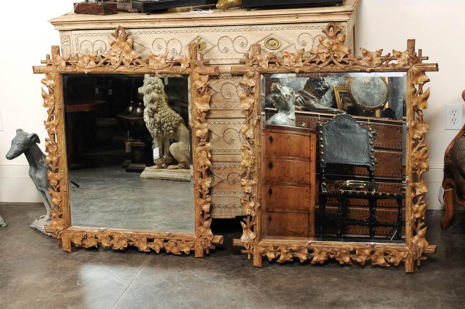  French Black Forest style mirror from the mid-20th century features a faux-bois frame made of a variety of leaves nicely intertwined along the rectangular frame made of four faux branches put together. The clear mirror which provides great