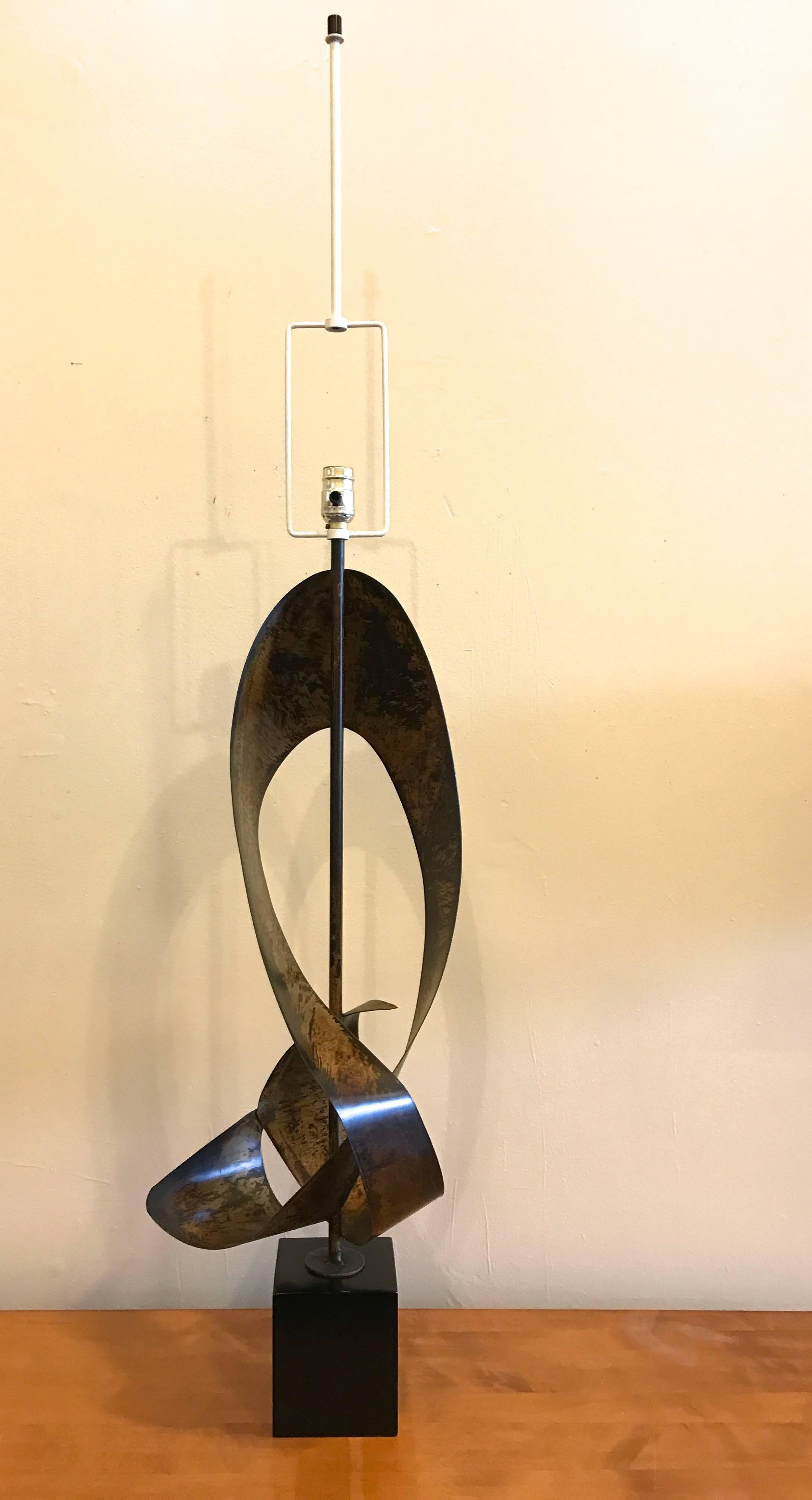 Brutalist metal ribbon sculpture lamp by Harry Balmer for the Laurel Lighting Company, circa 1960s. These lamps were created with an applied patina finish to give it a weathered appearance and the base was lacquered a satin black. The height of the