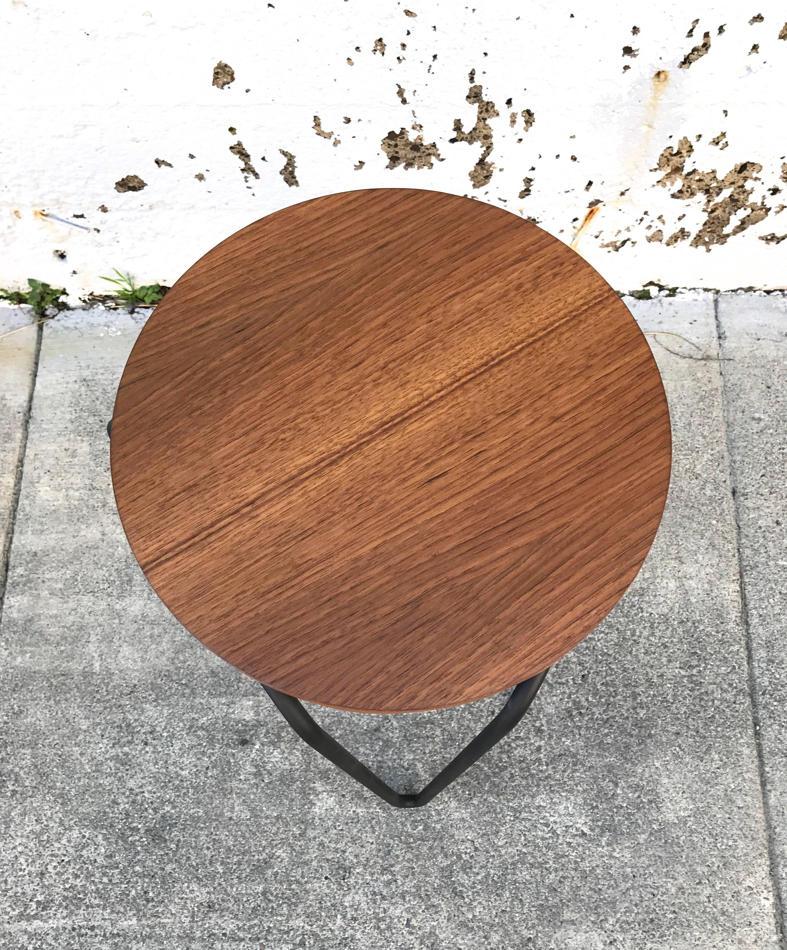 Early 1950s design by Florence Knoll is this painted iron and circular walnut top hairpin legged stool or side table. Restored top and lightly touched up base.
