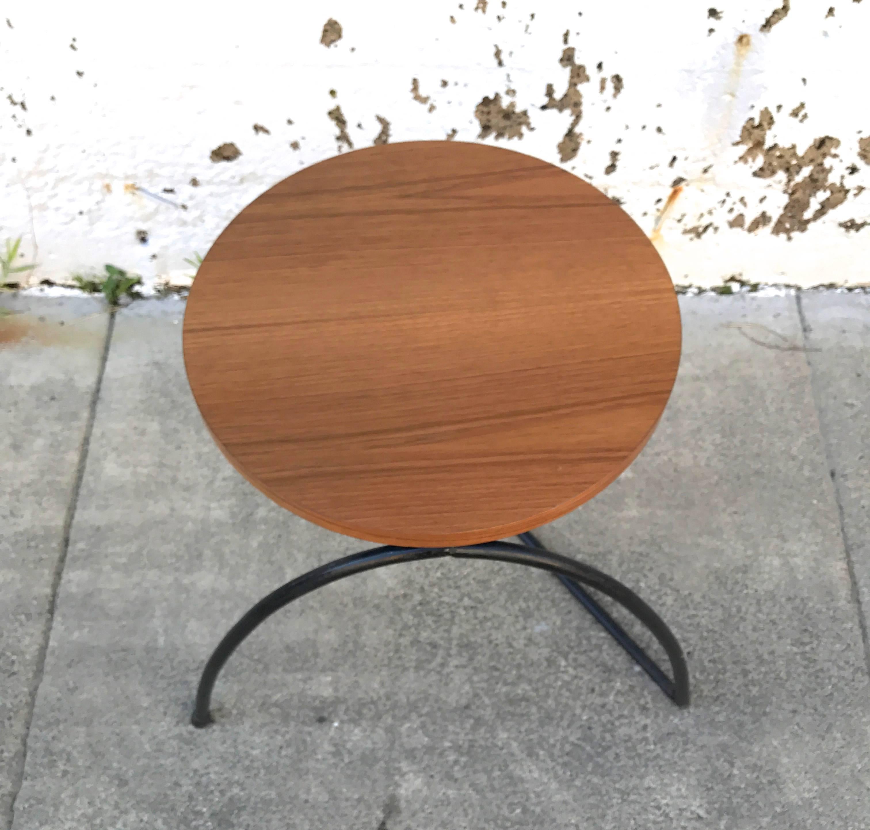 A unusual design in iron and walnut is this early 1950s Modernist stool/side table, integrating a curve and sharp angle in its base with a circular walnut top. The top has been restored and the base given a light touch up of paint. I've only seen a