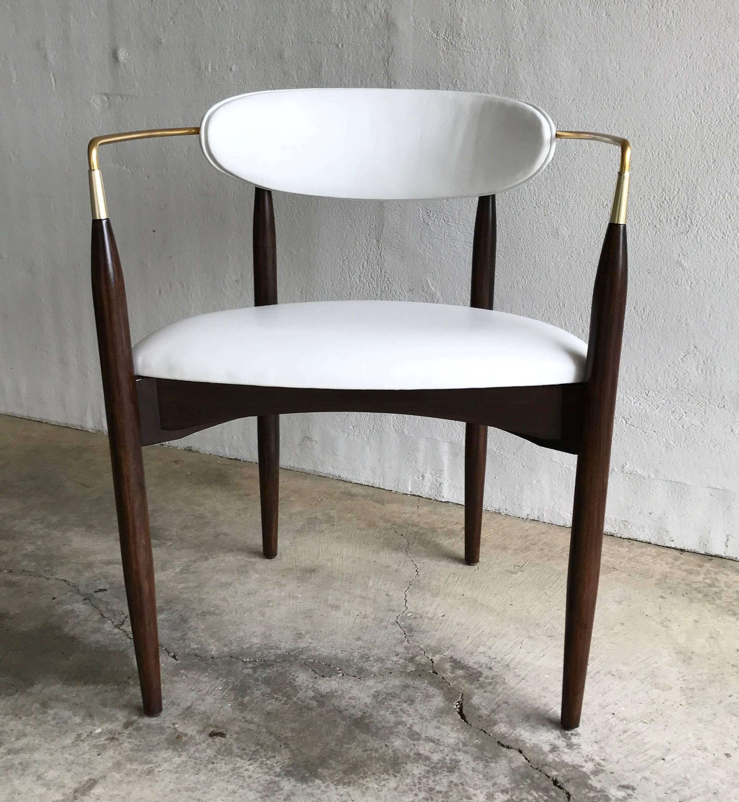 Selig armchair newly upholstered in a soft off-white leather and the wooden refinished in a rich dark brown. The arm is a circular brass band starting from the front arms / legs and wrapping around the seat back.