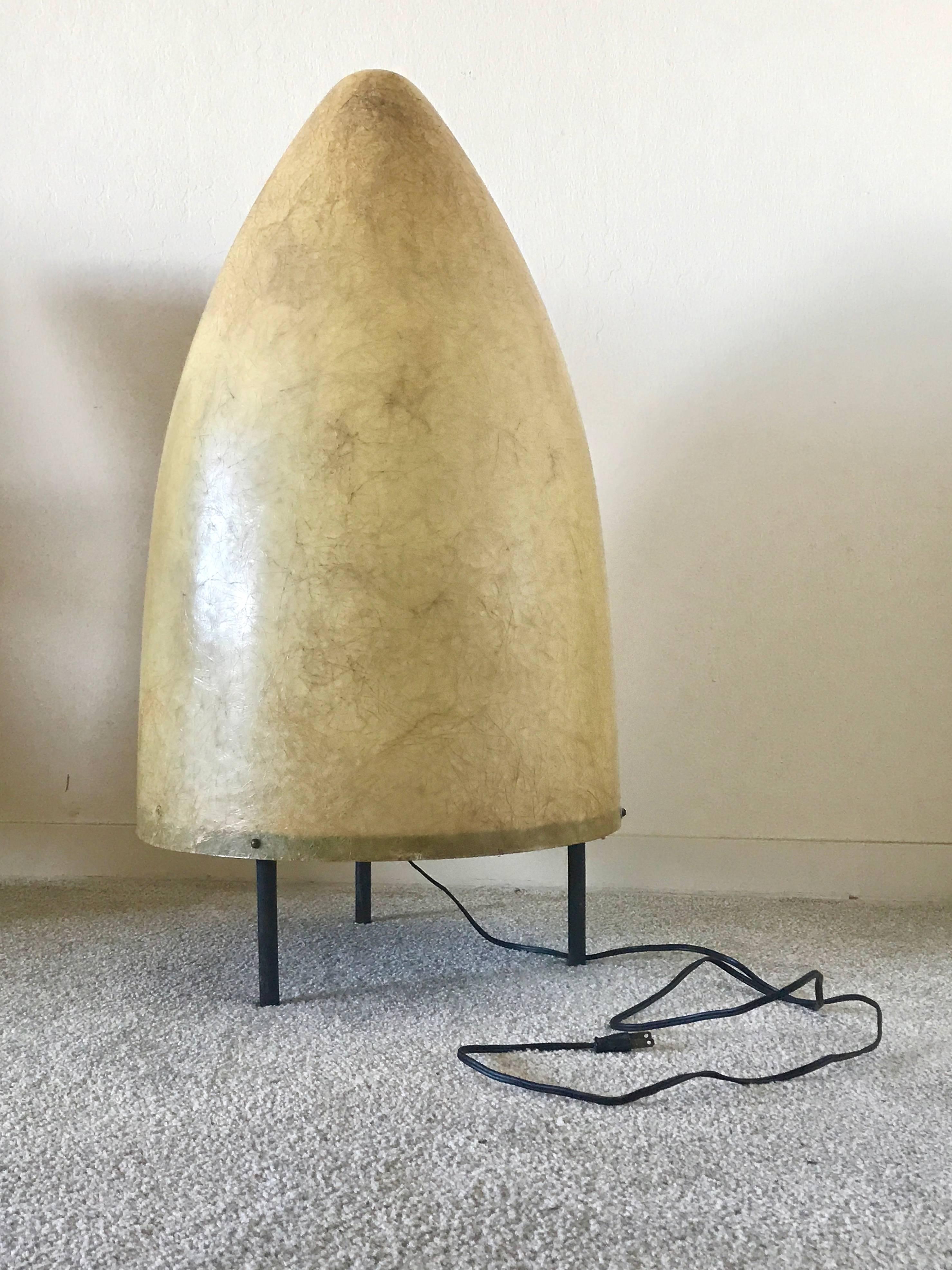 An creative use of Industrial Design materials for lighting from the early 1950s is this lamp constructed from a fiberglass cone and attached to a painted wooden tripod base. The fixture can be used either as a floor lamp or a large scale table