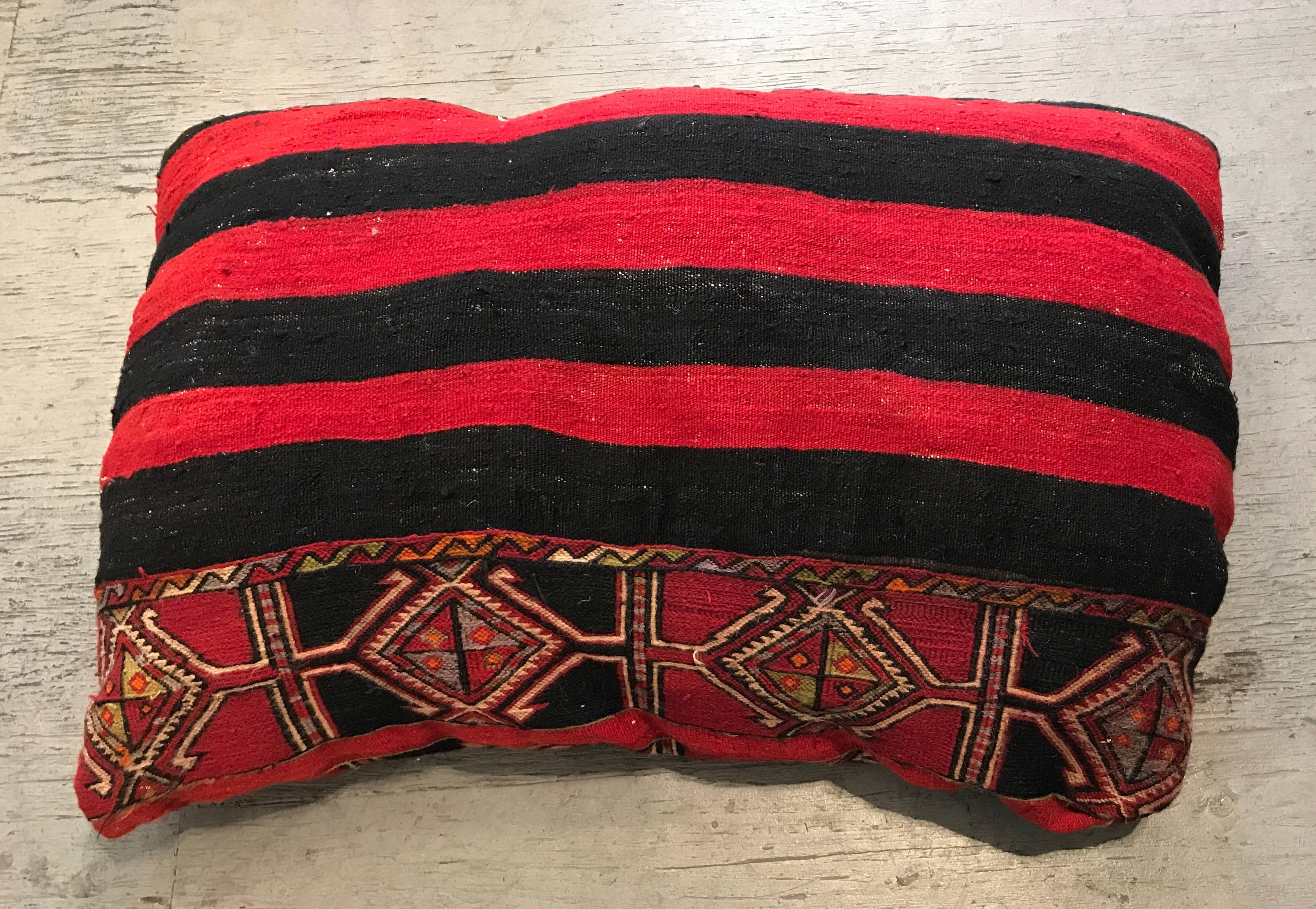 Large wool camel bag Kilim converted into a large sitting pillow, primary colors are black and red.
