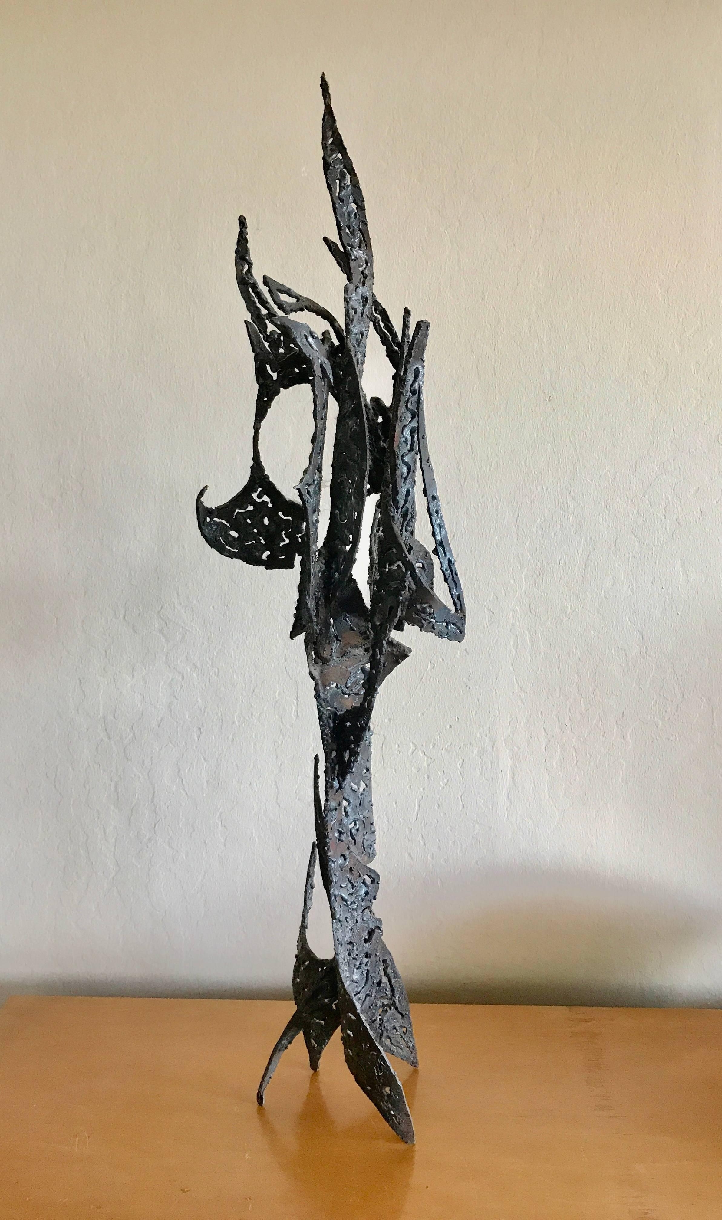 Torch cut abstract metal sculpture by Win Ng, moving forms that intersect each other to create this study in metal. Ng was a graduate of the San Francisco Art Institute in 1959 and has over 100 exhibitions of his work from 1959 to 1987, his work is