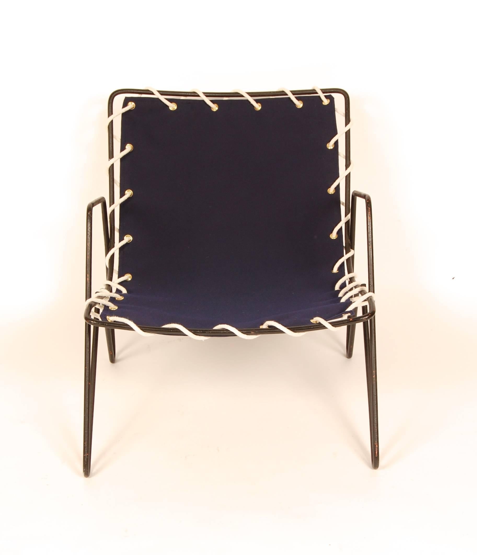 Modernist wrought iron frame lounge newly covered in blue marine grade canvas with brass groments and cotton cord. Clean Minimalist design for either indoor or outdoor use.