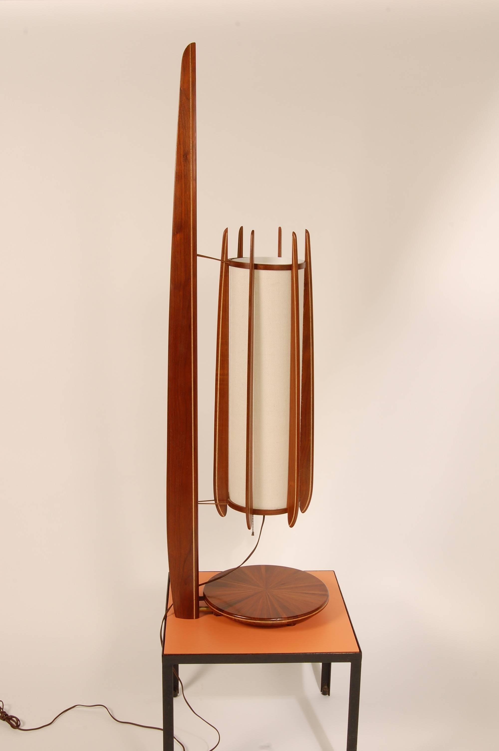 Sculptural one of a kind studio table lamp of amazing form and scale. Painstakingly created out of different species laminated walnut. The shade support has a series of copper rungs to hold it in place. The various sections of walnut in the base