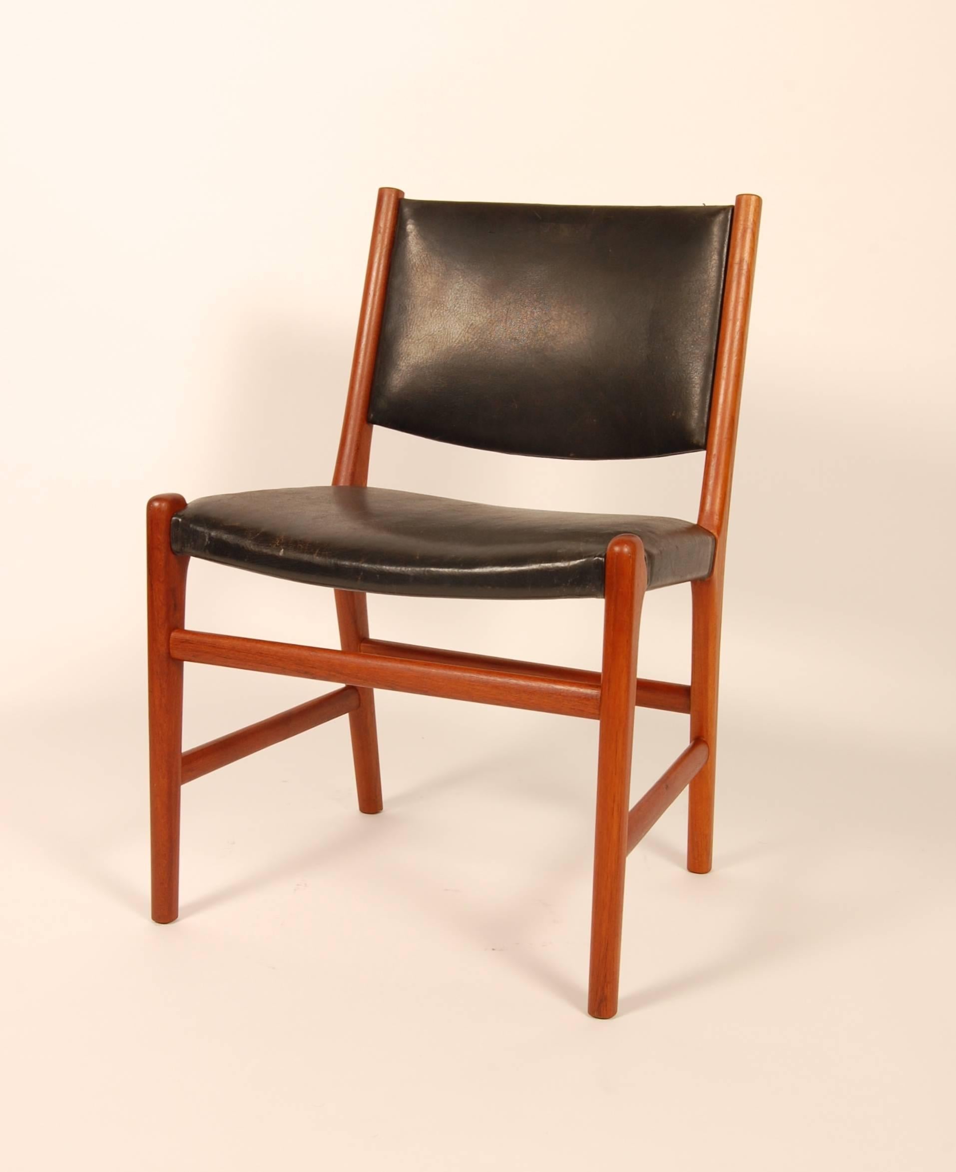 All original condition Hans Wegner for Johannes Hansen side or dining chair in a richly age toned teak with patinated leather upholstery. Straightforward architectural approach to the form with a wide seat and back and excellent comfort geometry.