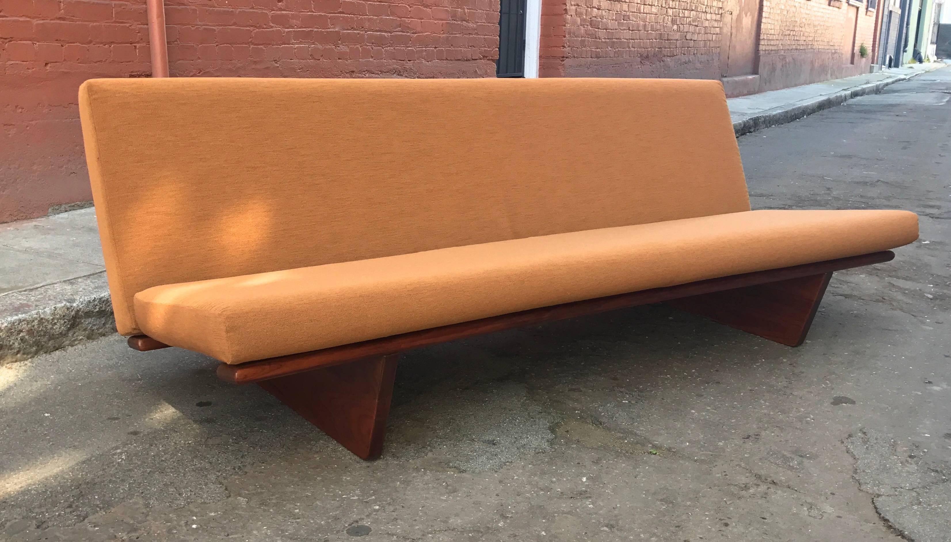 Early 1970s era conversion sofa into daybed from Denmark, this piece has undergone a complete restoration on every level, the solid African wood frame has been refinished and lacquered, new foam, upholstery and all new Pirelli webbing. Having