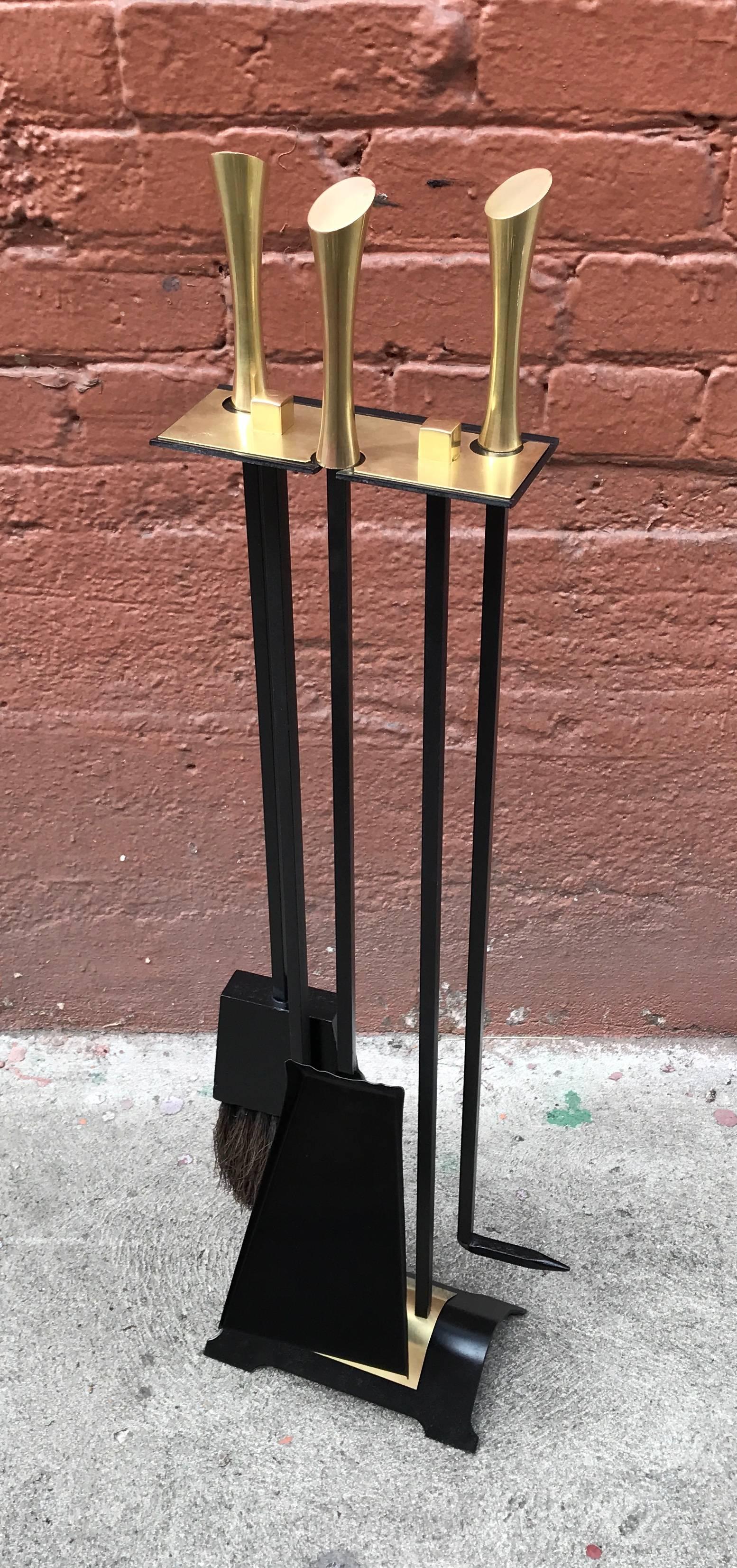 1950s wrought iron fireplace tools with brass accents, freshly sprayed with a high temperate black finish and hand polished solid brass hardware.
