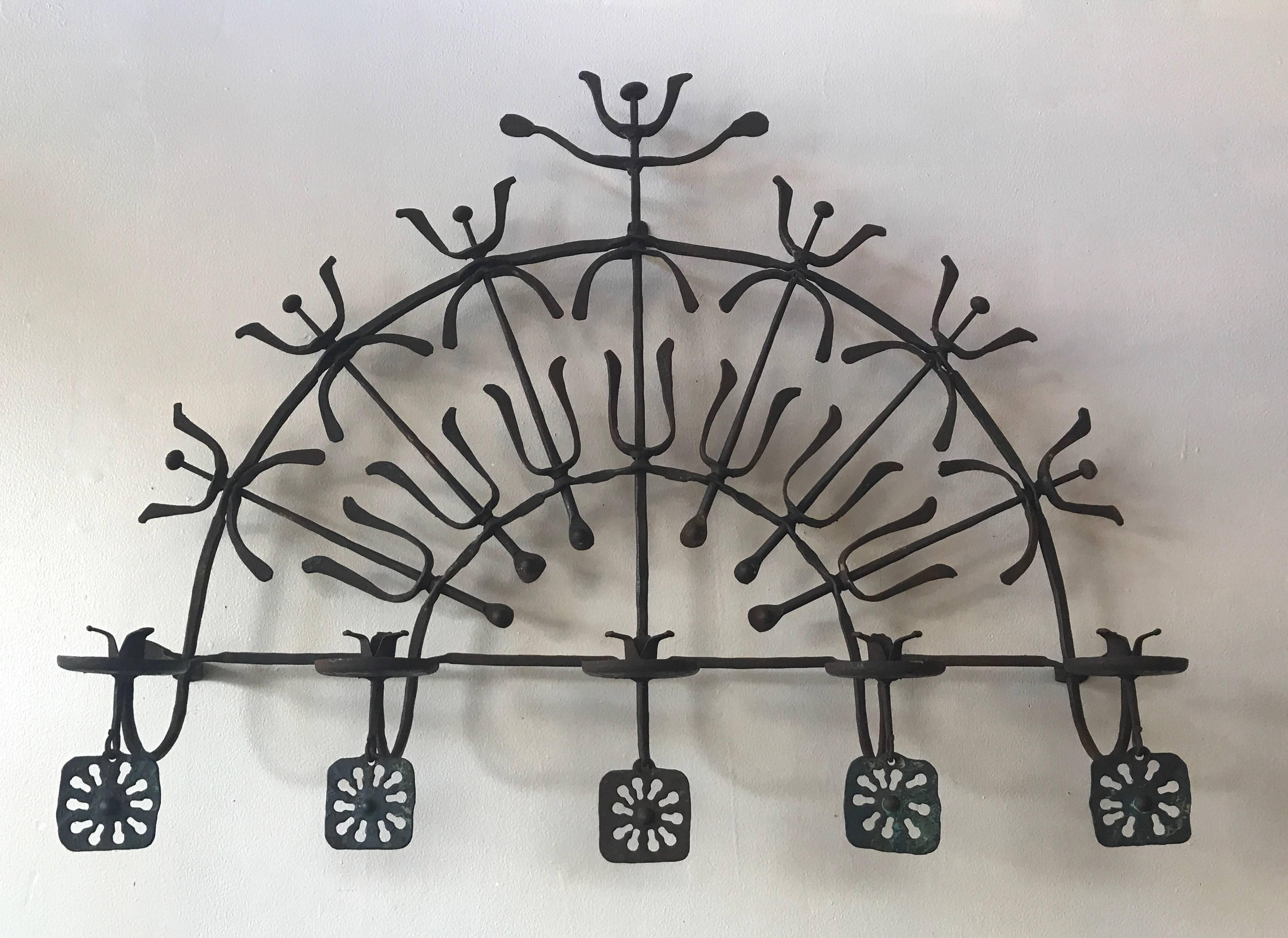 California blacksmith artist C. Carl Jennings hand-forged iron candelabra created in the 1960s in his studio El Diablo Forge in Lafayette east of Berkeley which he open in 1947. The candelabra has a series of five medallions reminiscent of suns and