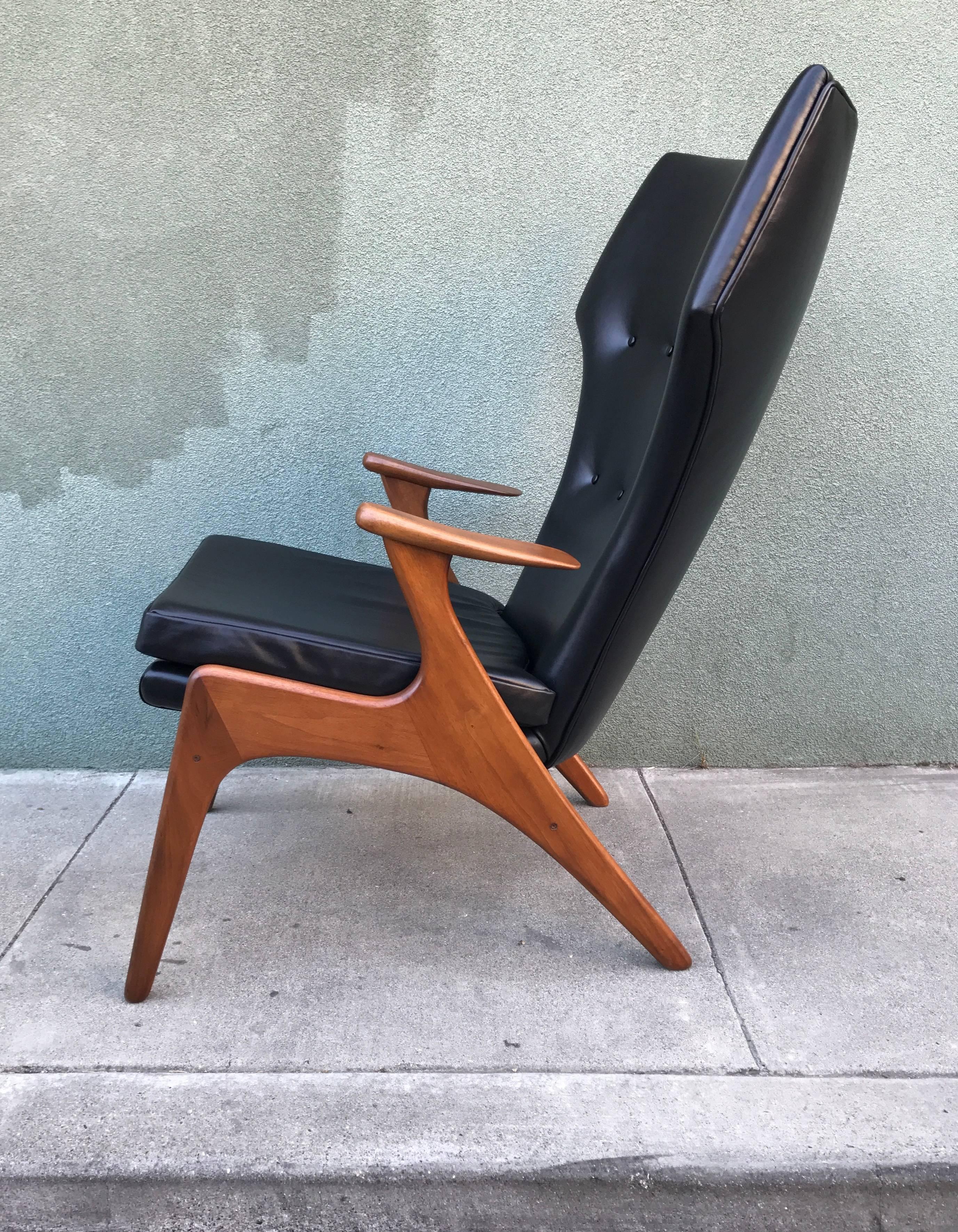 Kurt Ostervig wingback lounge chair completely restored upholstered in premium black leather, high grade foam, pirelli webbing and refinished walnut frame. One of the more architectural forms to come out of this time period.