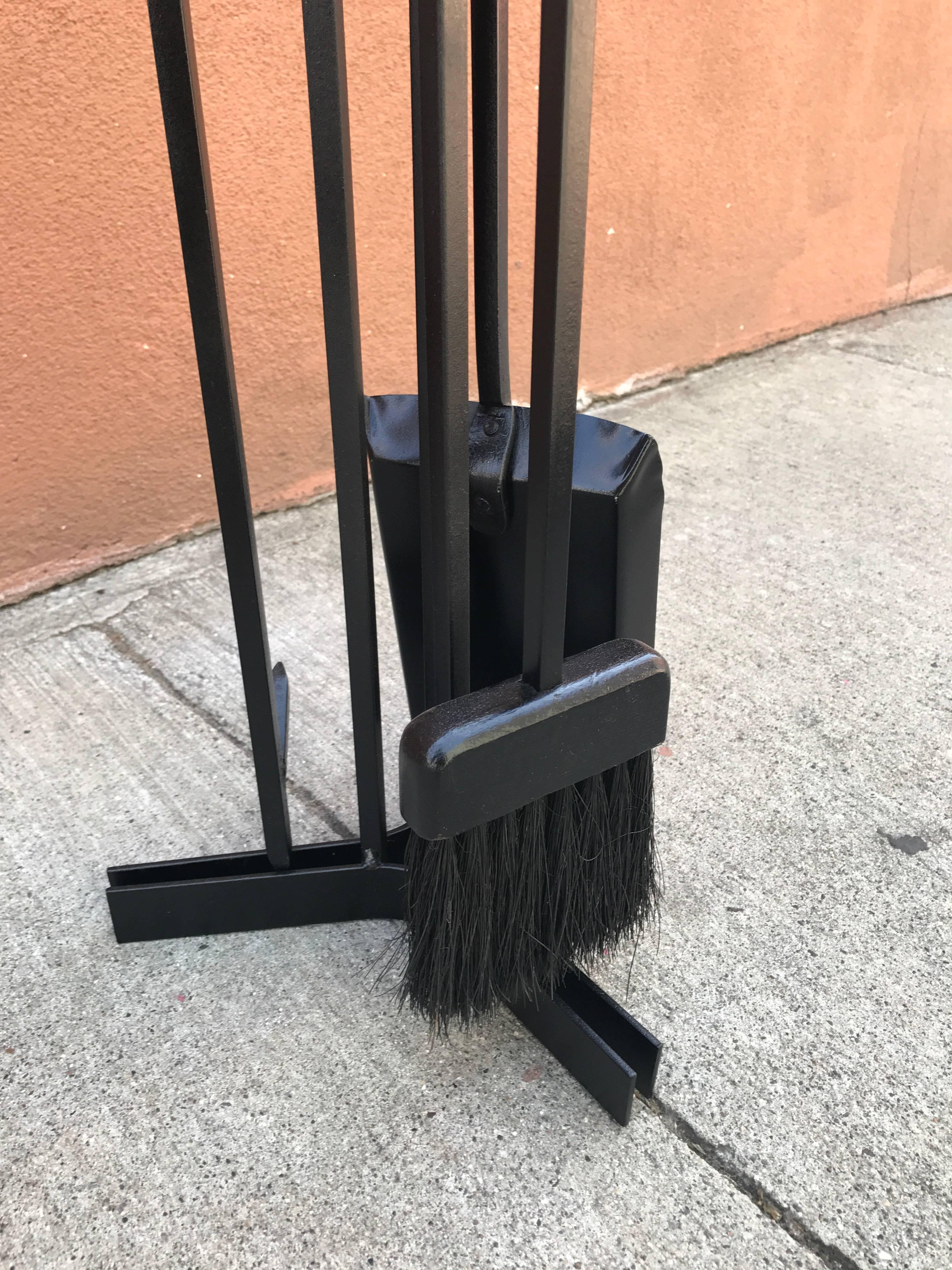Black lacquered iron fireplace tools with wood handles.