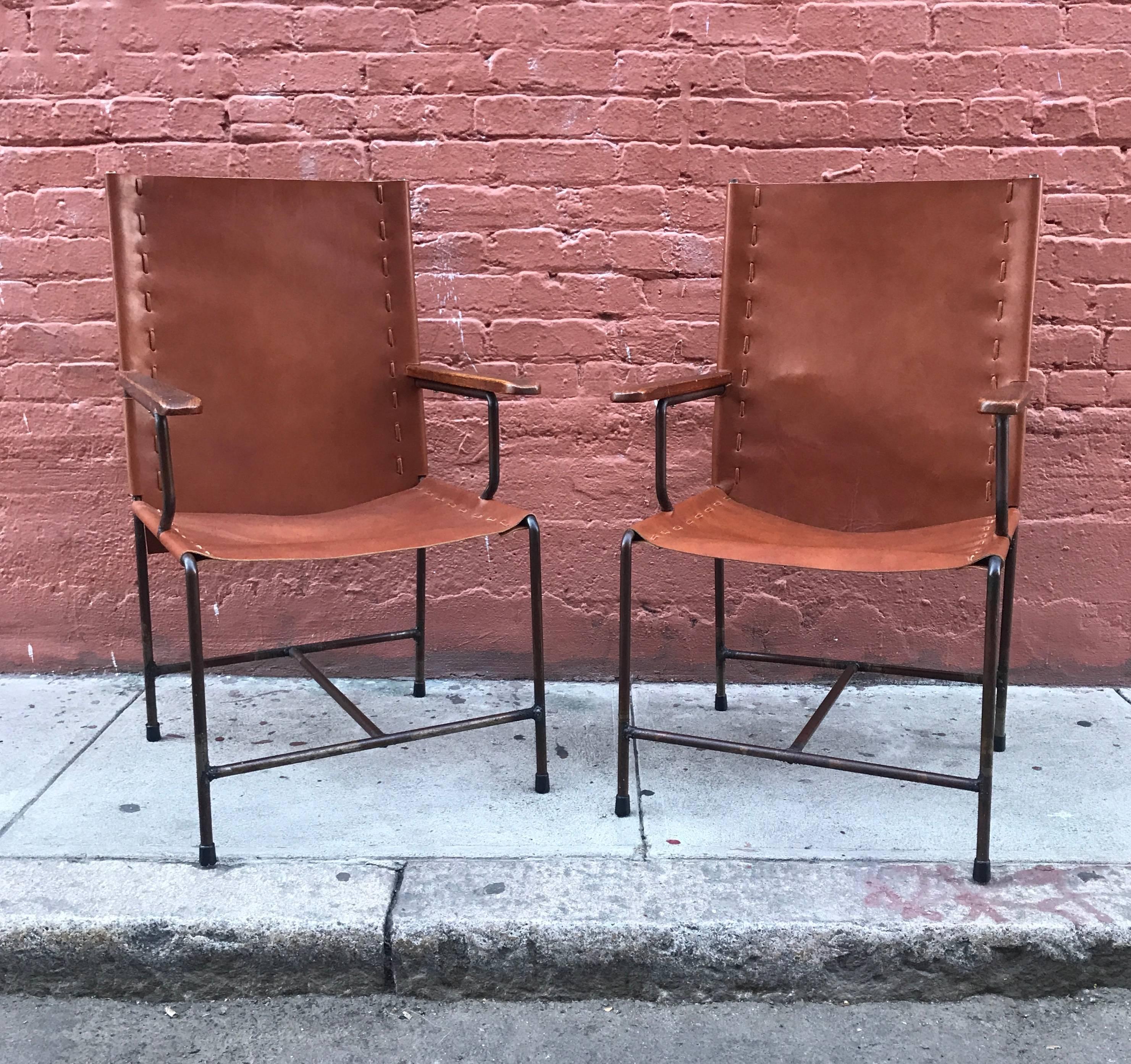 Mexican modern armchairs in leather with iron frames with wooden armrests. Created during 1950s these chairs are a blend of Rustic and Modernist design values. Newly upholstered in leather, the frames and armrests have been left in their original