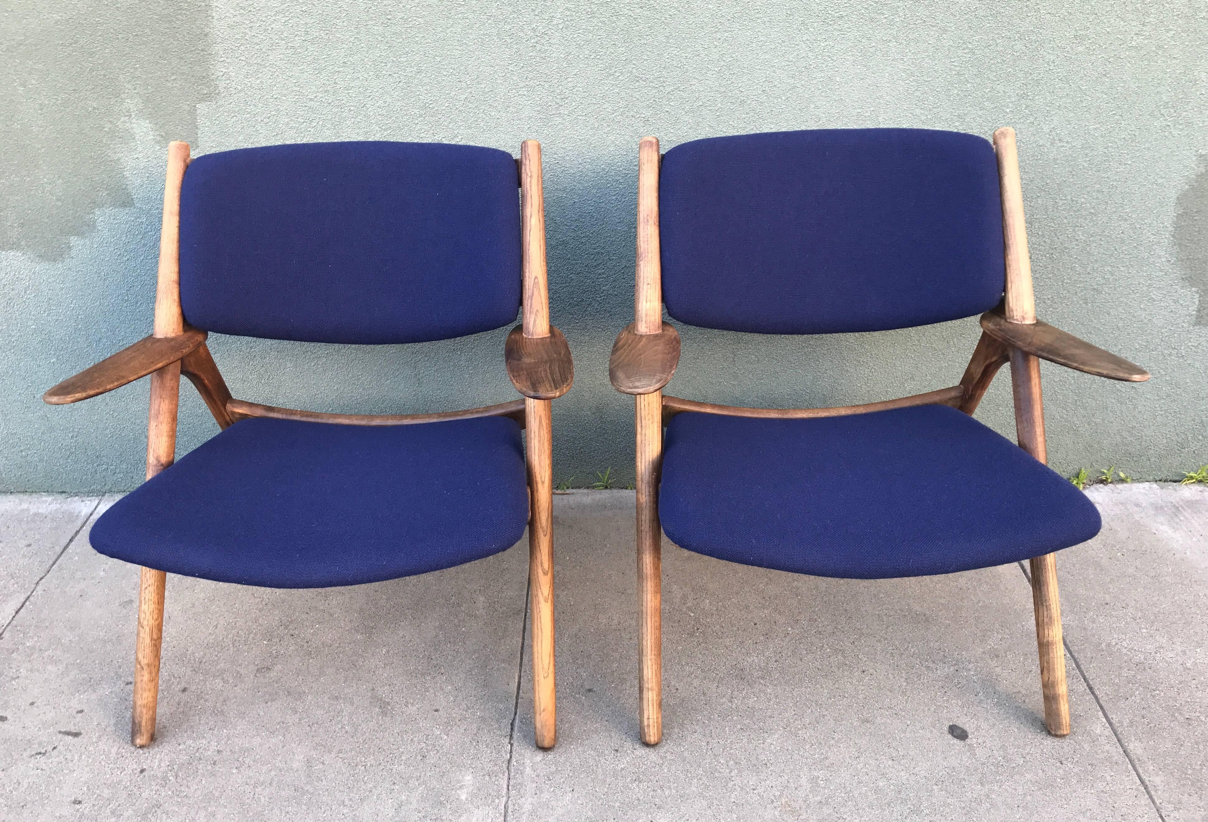 Beautiful pair of vintage walnut sawbuck lounge chairs, circa 1960s, Japan. Newly recovered in a dark blue Maharam fabric. Very comfortable wide seat and a great wood patina.