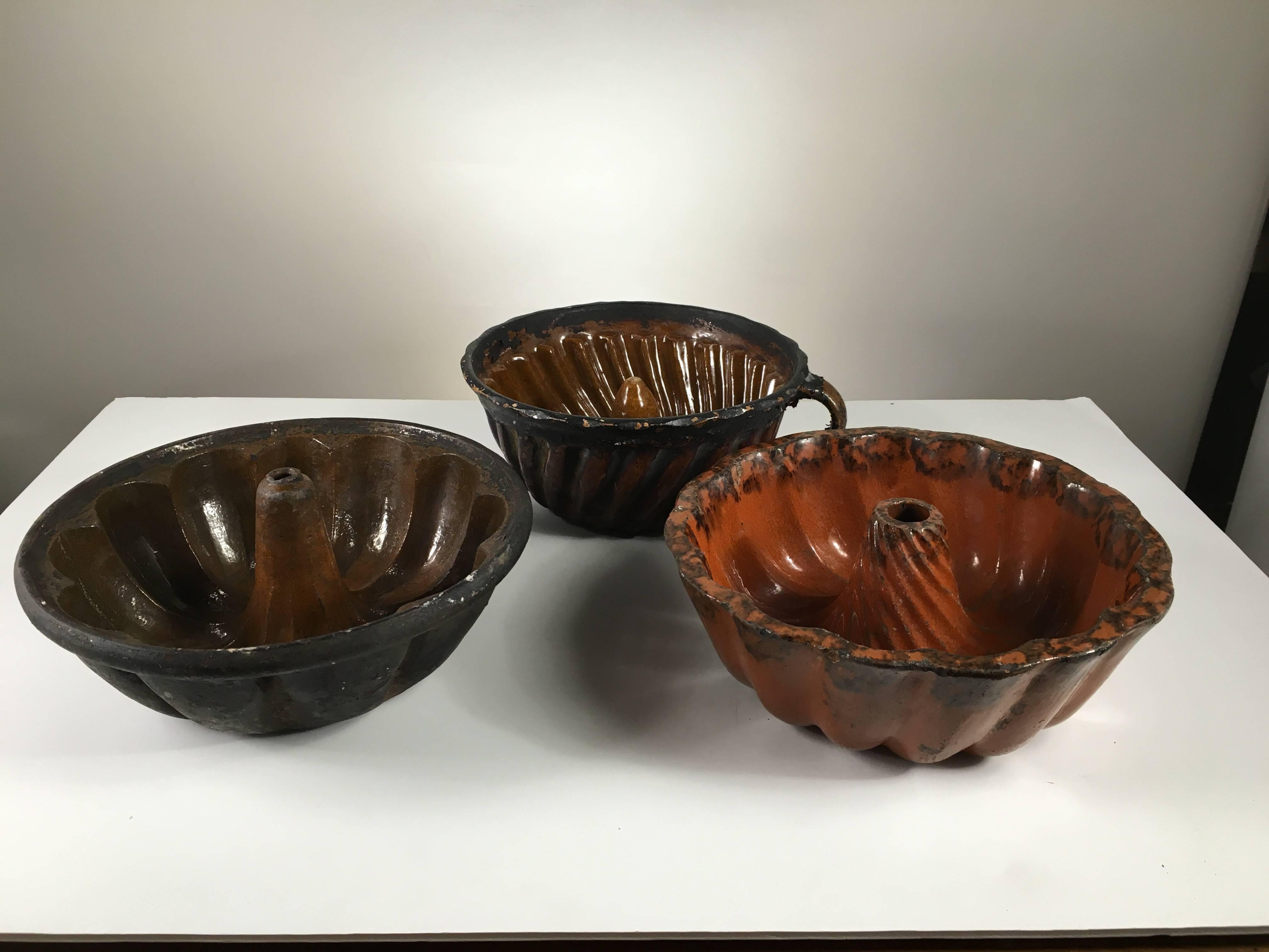 Country Collection of Three Early Pennsylvania Redware Cake Molds, 19th Century