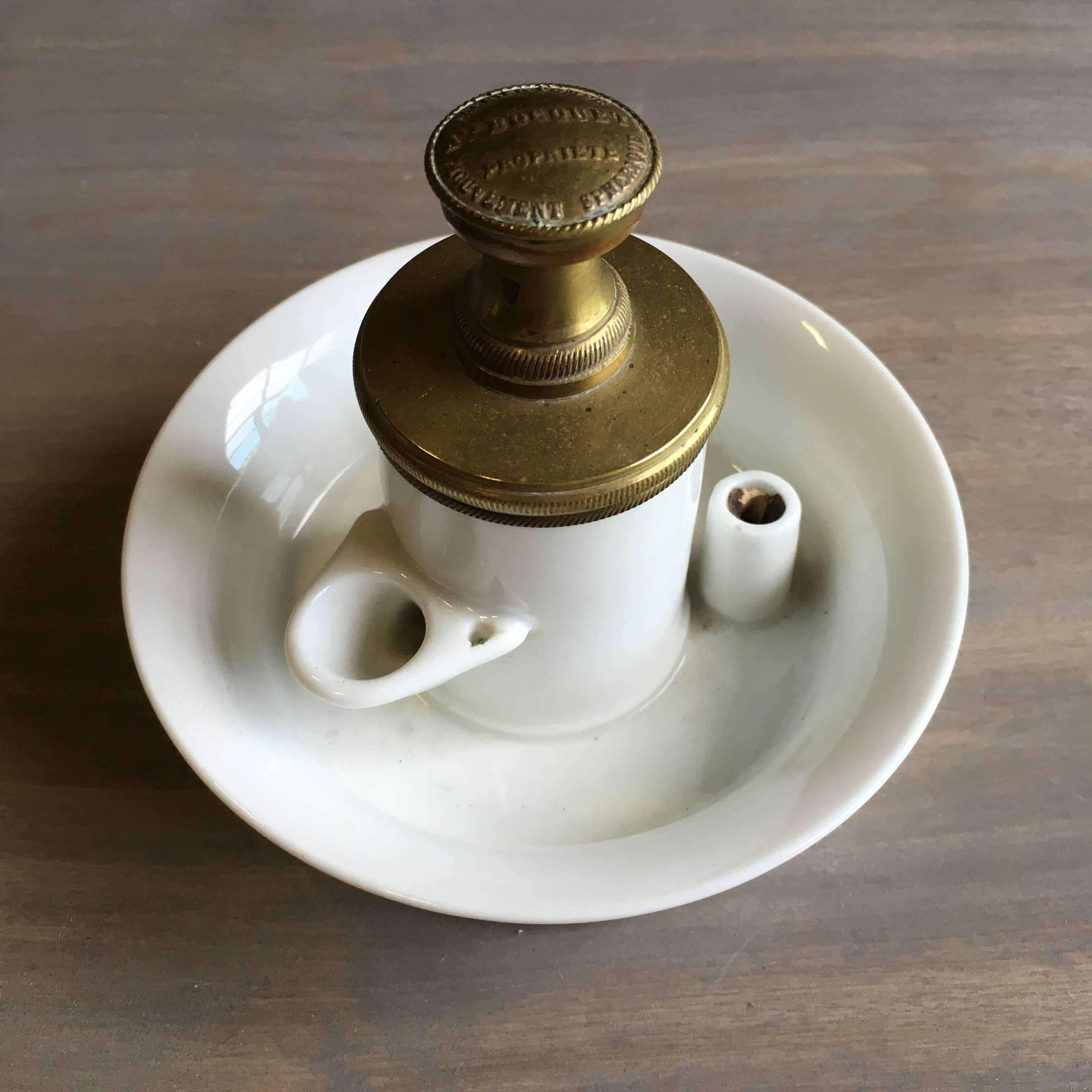 A French Empire period porcelain and brass gravity feed inkwell, complete with all internal parts, circa 1810. Signed 