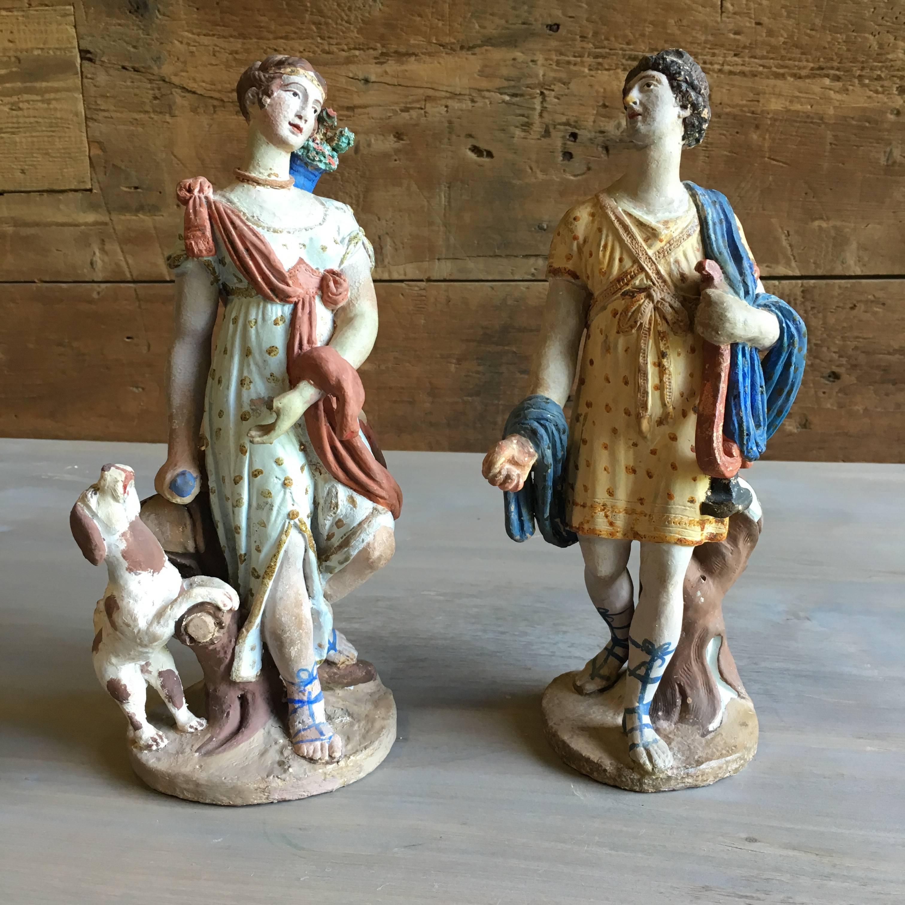 A pair of classical style figurines in painted terra cotta, French late 18th century. From the personal collection of Pierre Moulin, author of French Country style books and founder of the Pierre Deux shops.