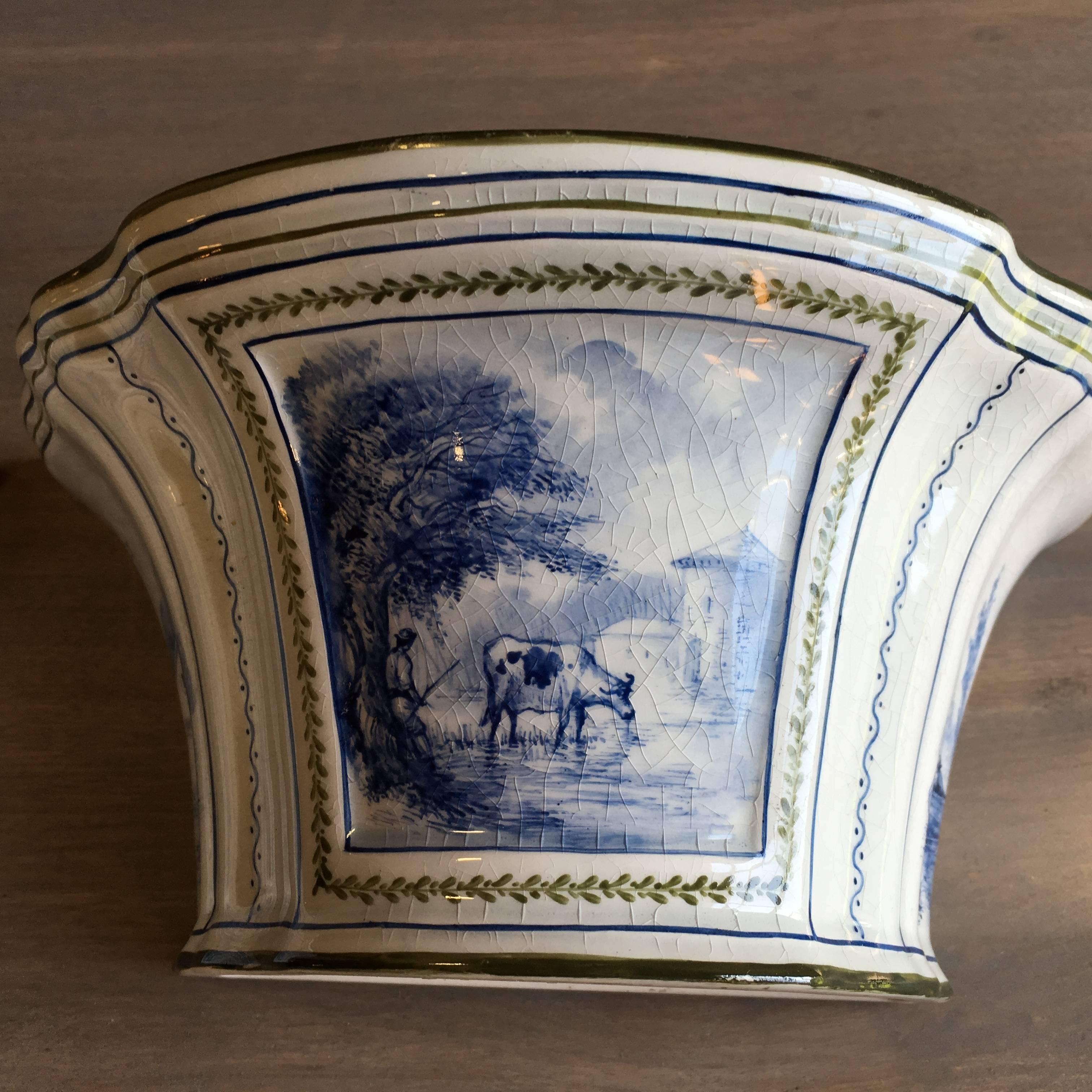 A fine pair of French flower holders (bouquetieres) in porcelain by Rovina Epinal, the noted factory in the St. Clement region, with pastoral scenes in blue on a cream white background, circa 1870.