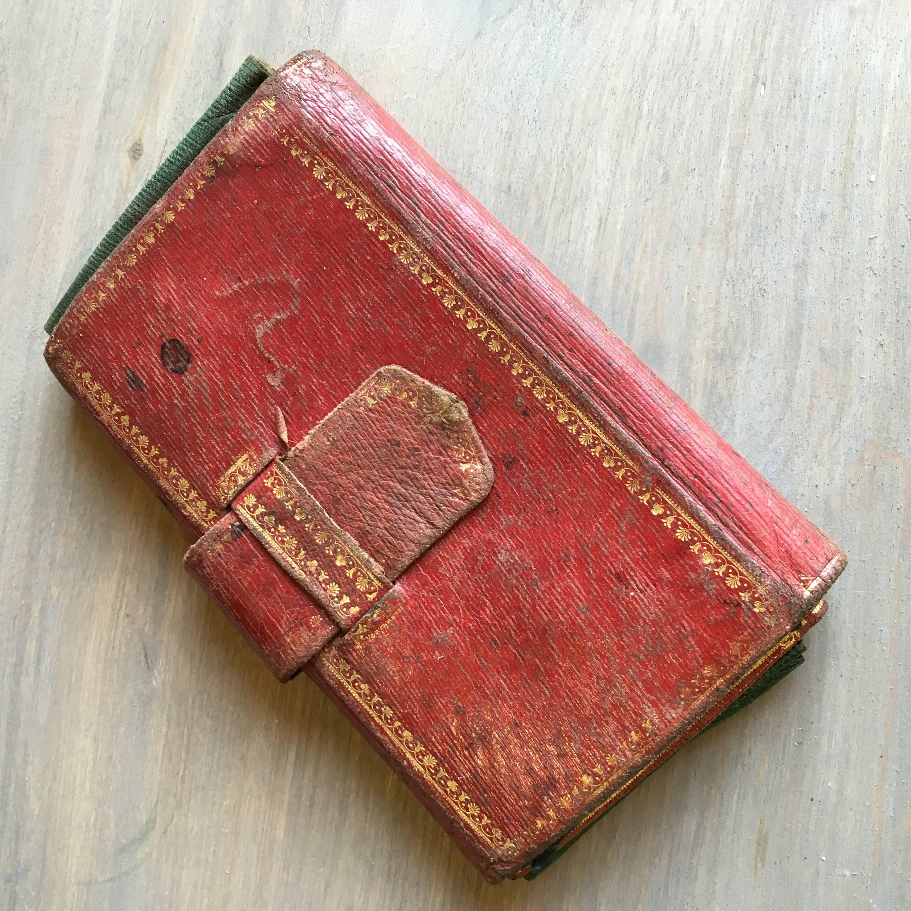 A charming 18th century letter pouch in red tooled leather with gilt decoration, circa 1760 with bright green leather interior. Nice desk accessory.