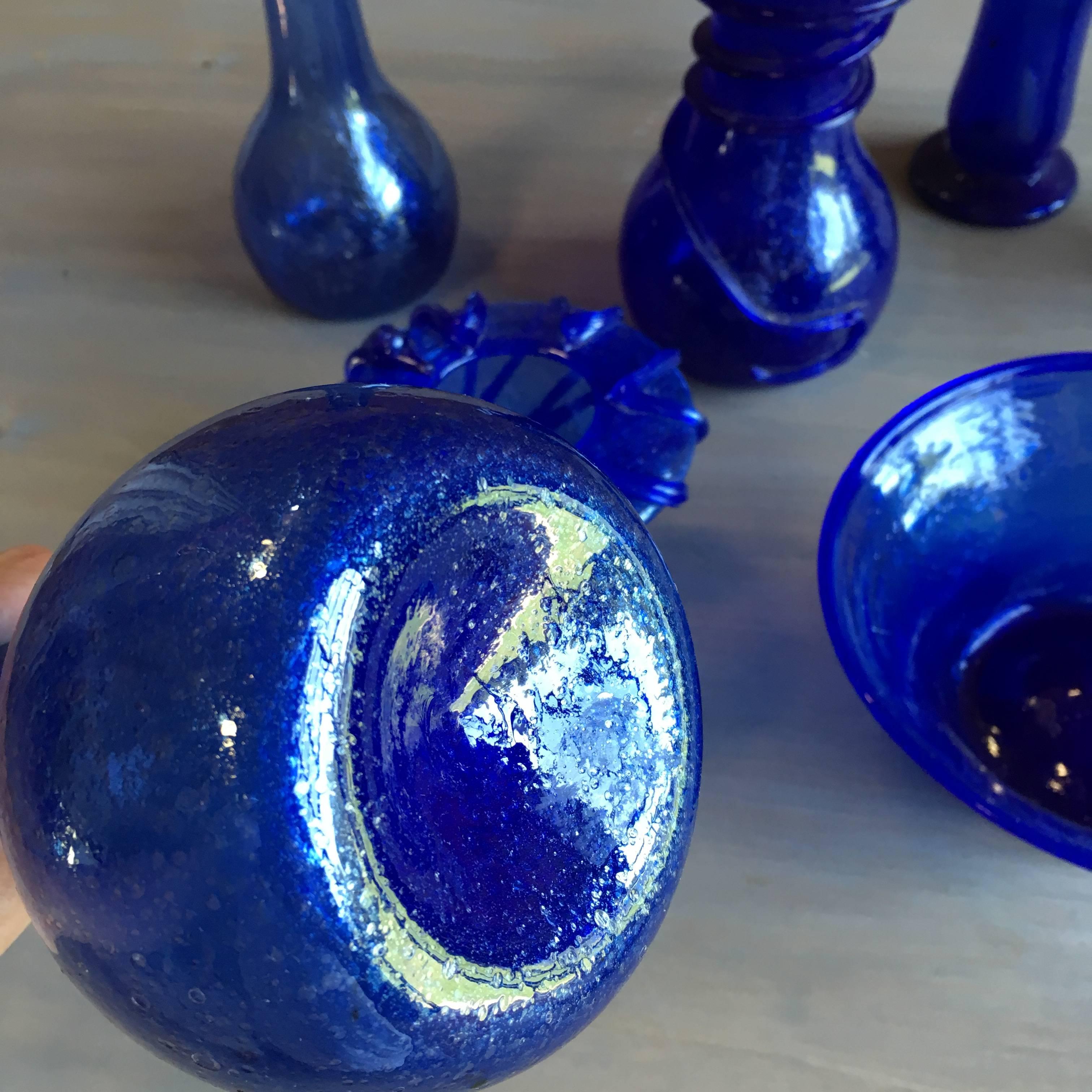 A collection of seven assorted pieces of blown-glass jars, bowls and vases from Herat, Afghanistan. They are from the last remaining place where glass is created as it was in antiquity, according to the Corning Glass Museum.
