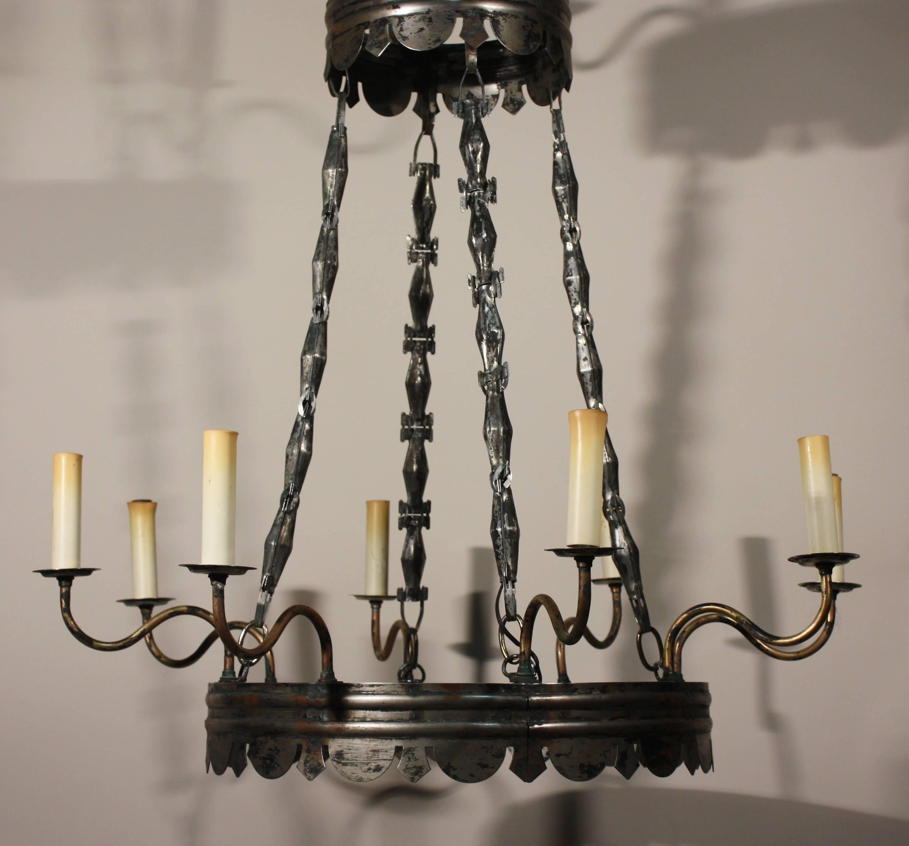 A wonderful tole and brass Empire Style 12-candle chandelier with a great form and patina.