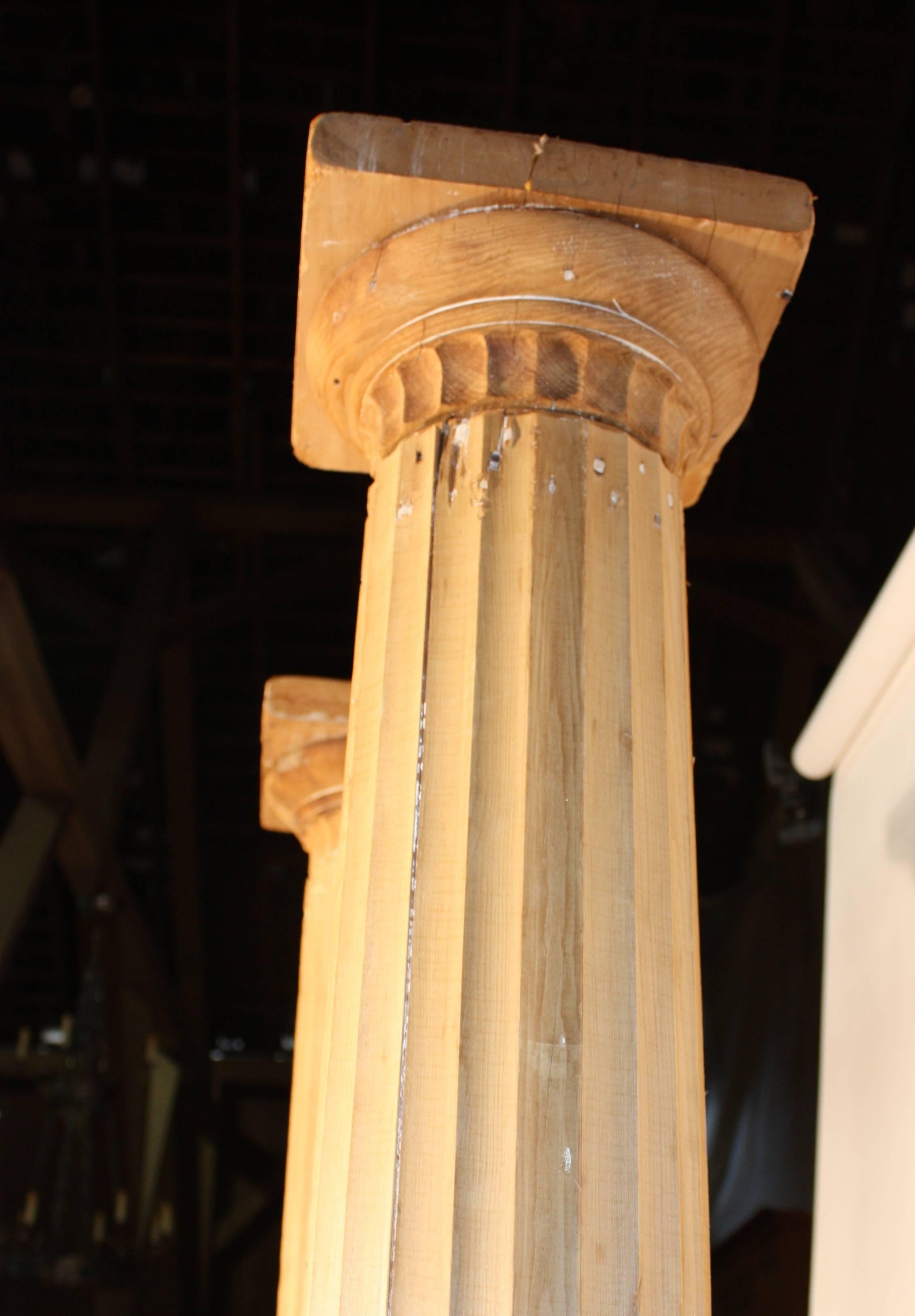 A pair of stripped and bleached pine architectural columns, circa 1870, found in Dutchess County NY, each in two parts, with square pedestal bases and fluted upper section.