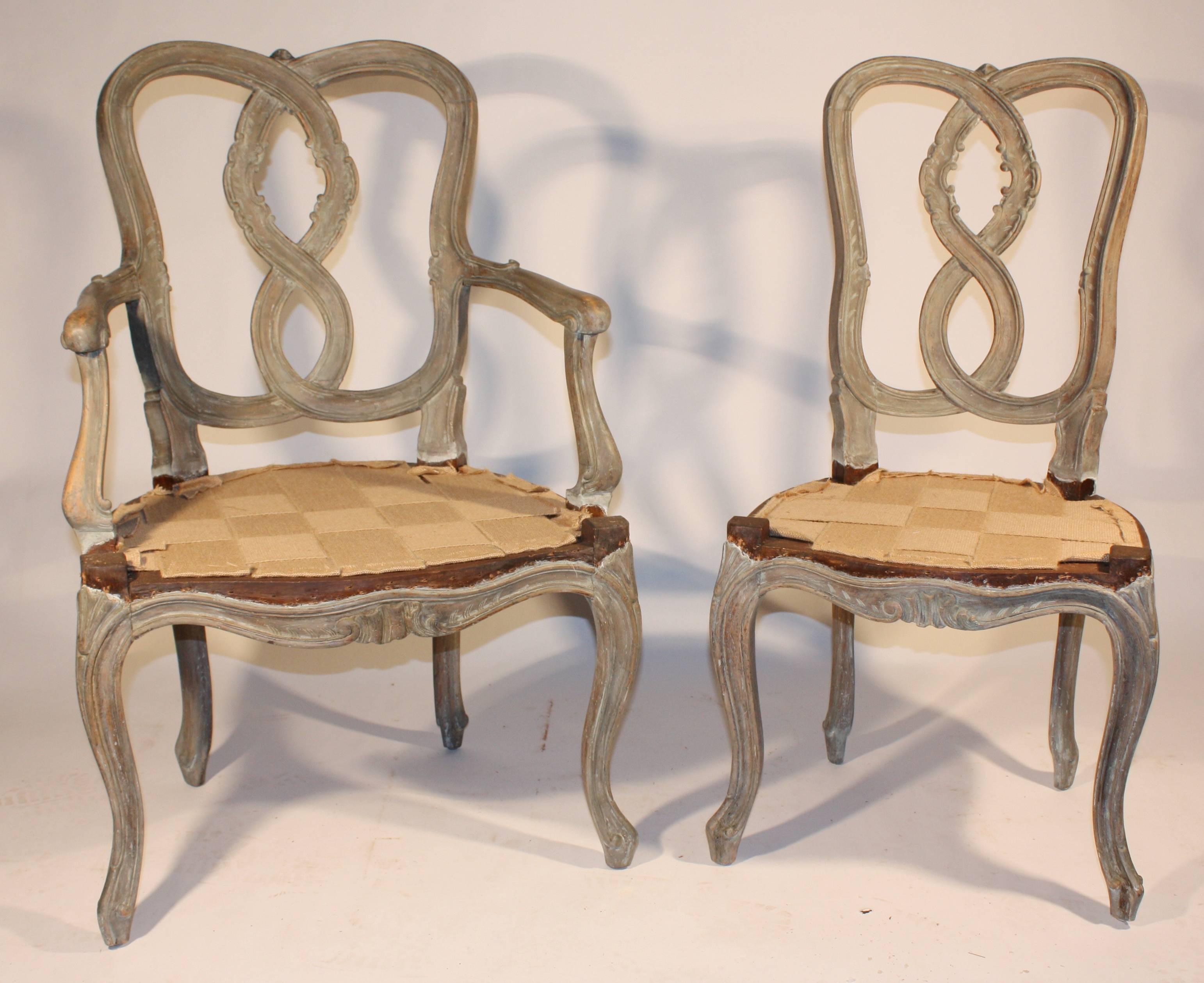 A charming set of six (two arm, four side) late 19th century, Italian dining chairs in the Venetian manner, partially stripped with a distressed verdigris-green painted finish. Ready for upholstery with new webbing and recently re-glued. Nicely