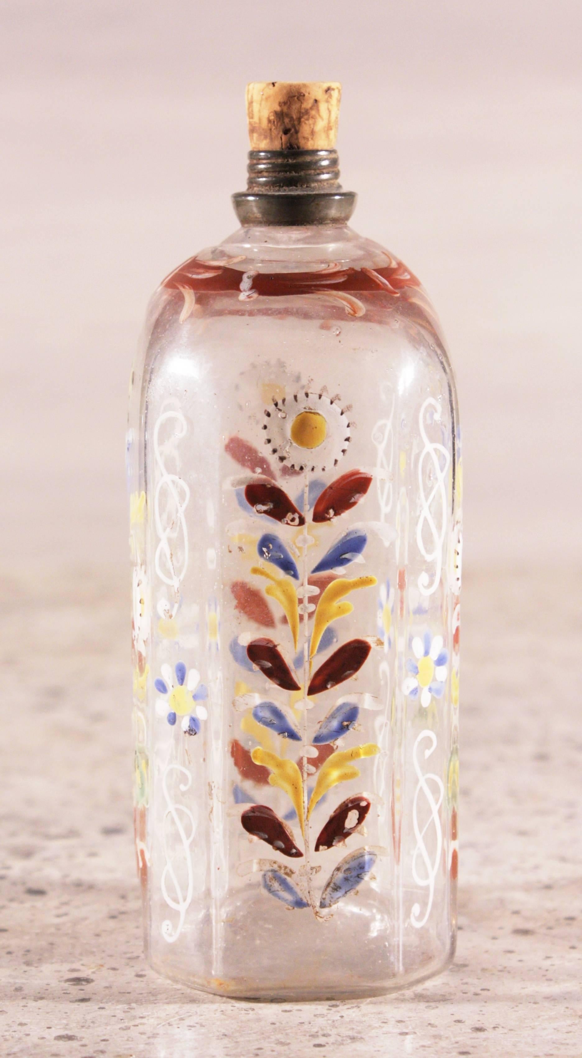 A sweet little enamel decorated decanter or scent bottle attributed to the Baron Stiegel glassworks, circa 1790 with pewter threaded top (cap missing) and a Pontil scar on base.