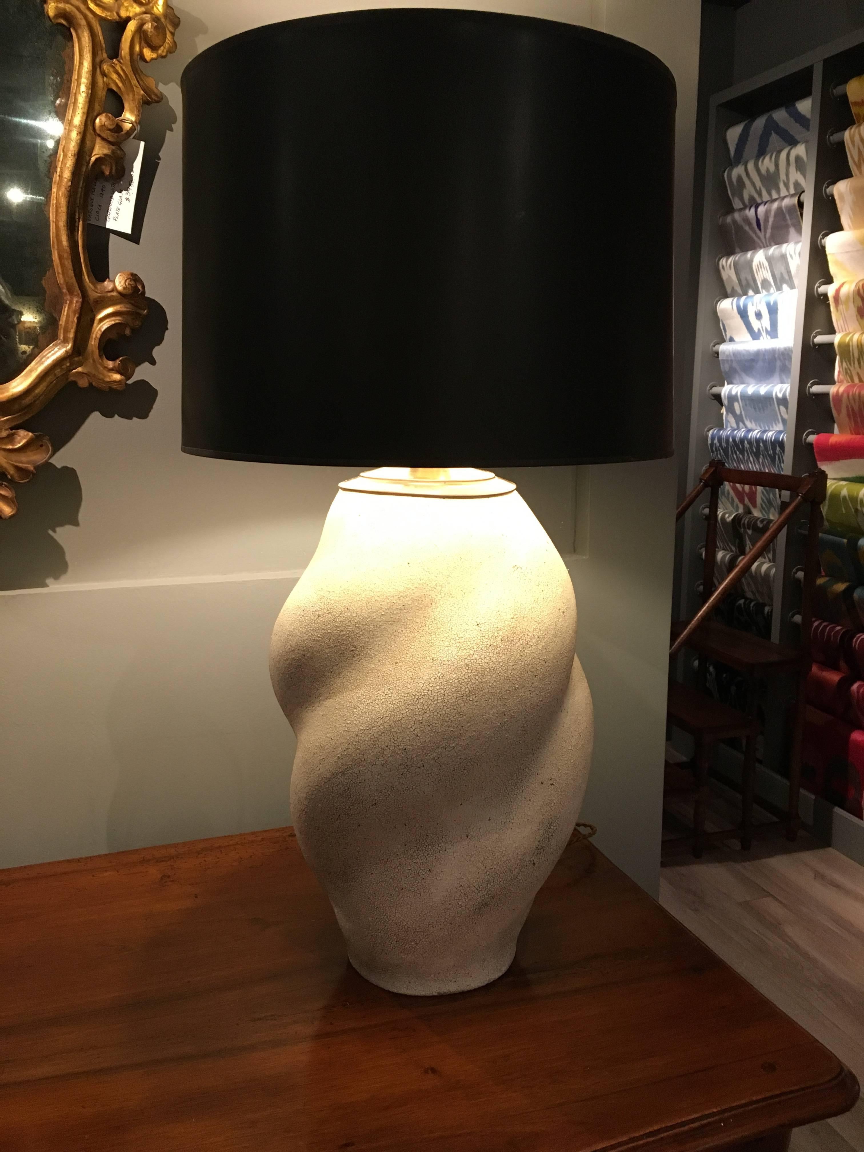 A contemporary glazed ceramic table lamp in vase form by artist Yumiko Kuga, with a dry white crackle glaze, and a brass cap and braided fabric wire.
Signed on bottom. The vase was made as a lamp and has not been drilled, but created with a wire