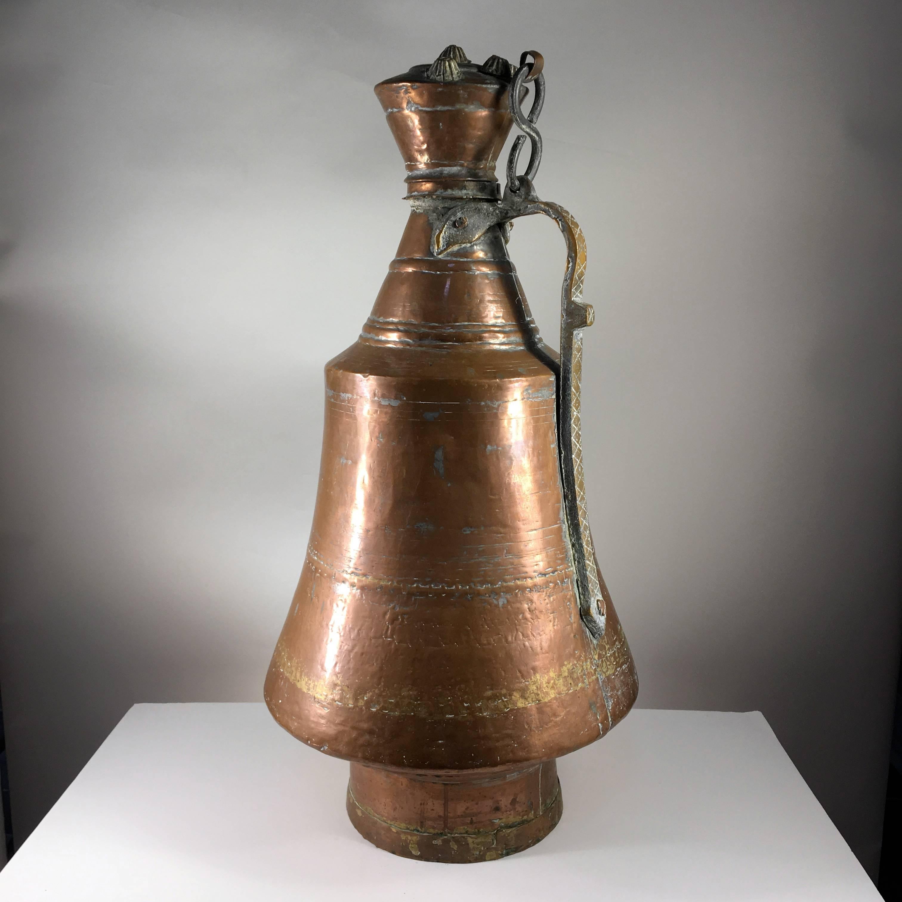 A pair of large copper and brass wine storage jars, hand-hammered, likely from Morocco, early 20th century. Could be mounted as a great pair of lamps.