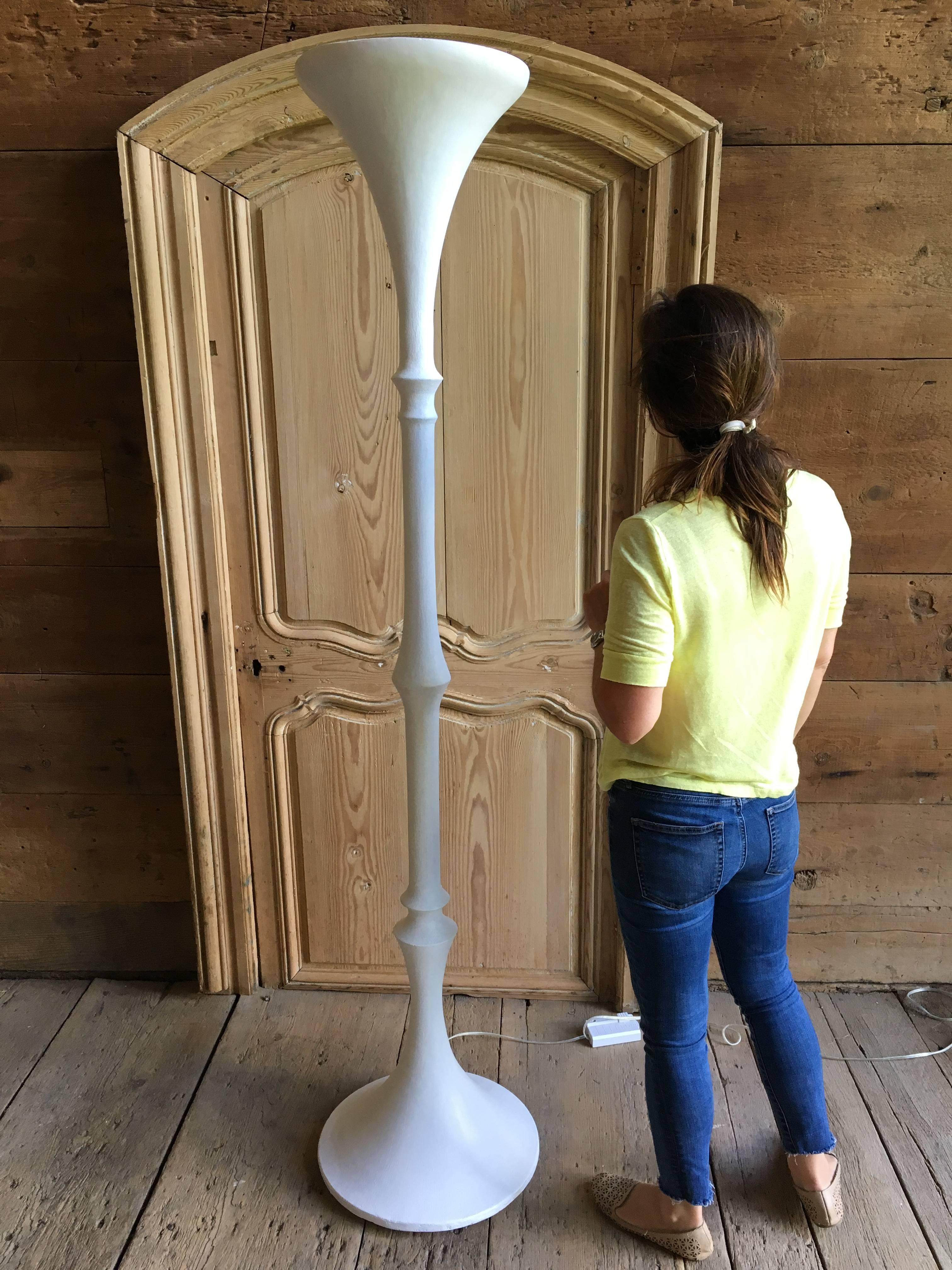 A large and impressive plaster torchiere floor lamp in the manner of Giacometti, French, circa 1950, rewired with halogen bulb and dimmer switch.