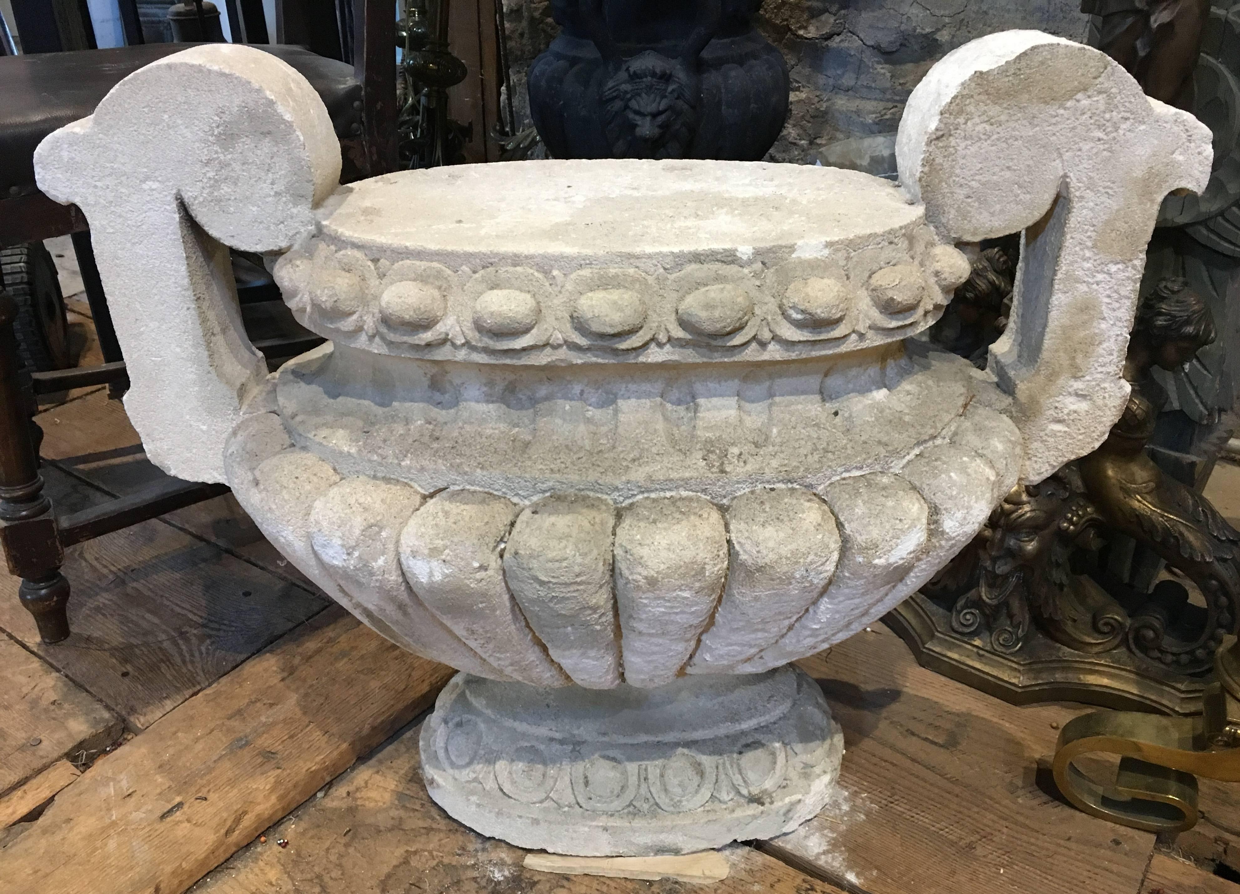 A nicely sculpted Louis XVI style limestone urn-form finial, with two handles, the perfect size and height for use as a garden seat, 19th century, French.