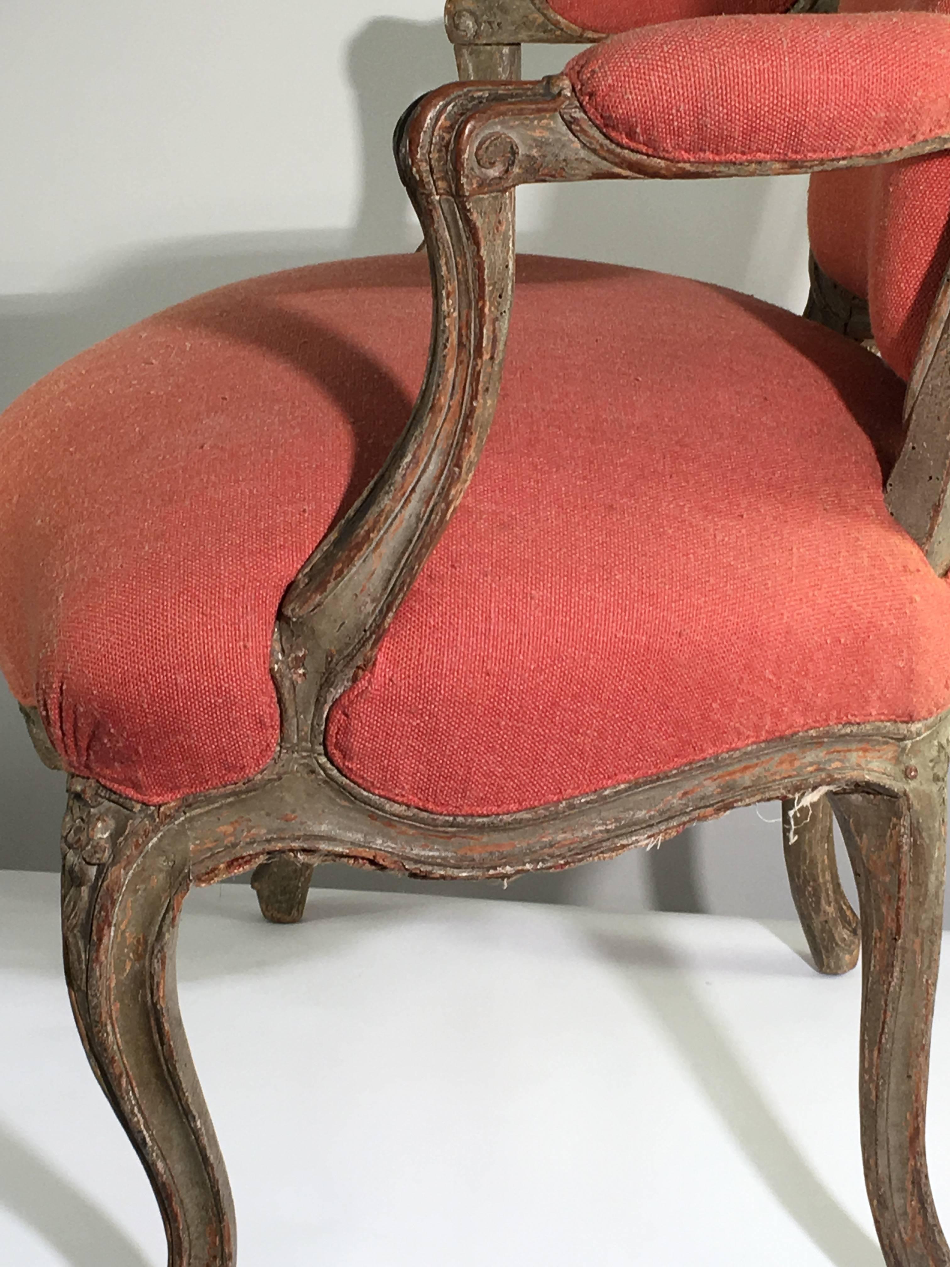 A late 18th century Louis XV armchair "fauteuil cabriolet" in original grey painted finish, currently upholstered in a coral red wool fabric. Nicely carved seat and back crest with well modeled arms.
A nice size not too small.