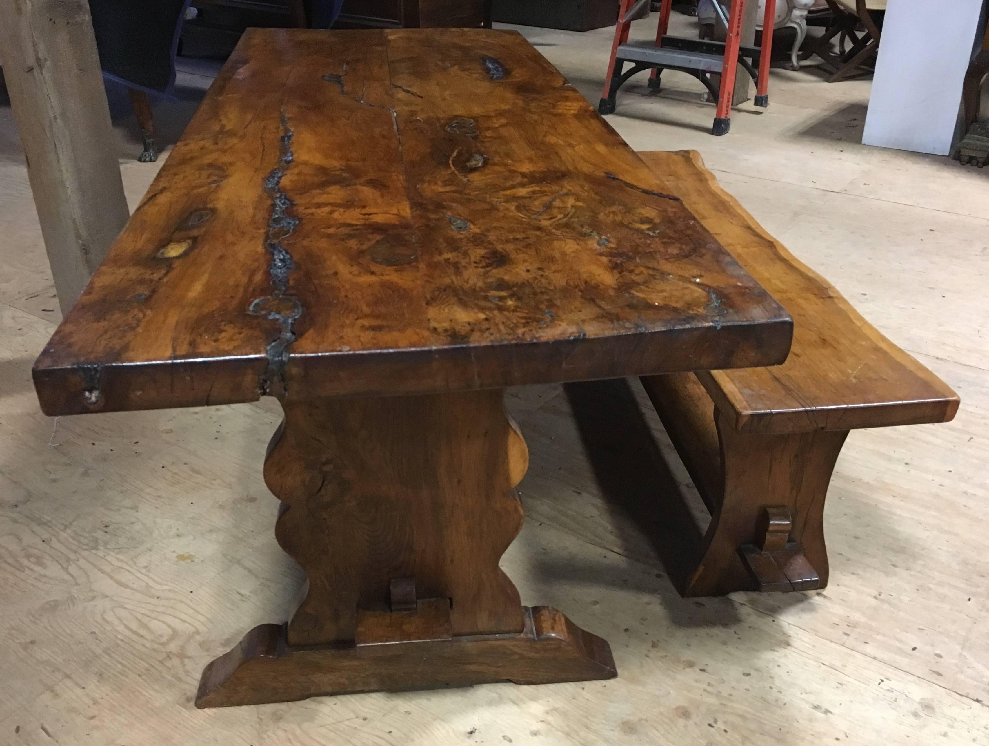 A rustic yew wood slab-top trestle table, 19th century English, with natural imperfections, available with a matching bench (sold separately). The top is two boards 2