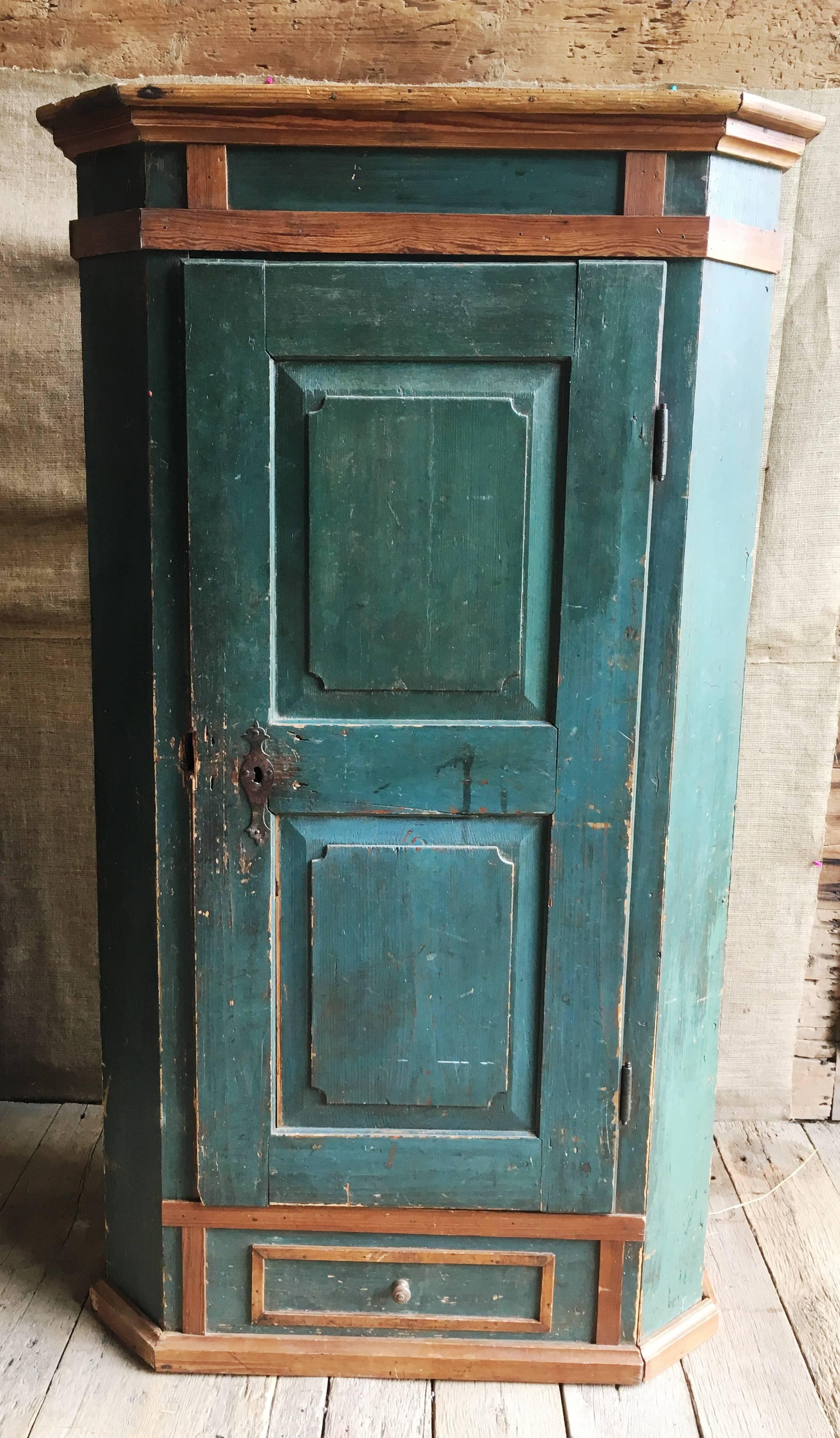A charming 18th century painted pine single-door armoire or cupboard, probably Alps region, circa 1800 in original green-blue finish. The interior has hand-carved coat hooks and the front has a false drawer.