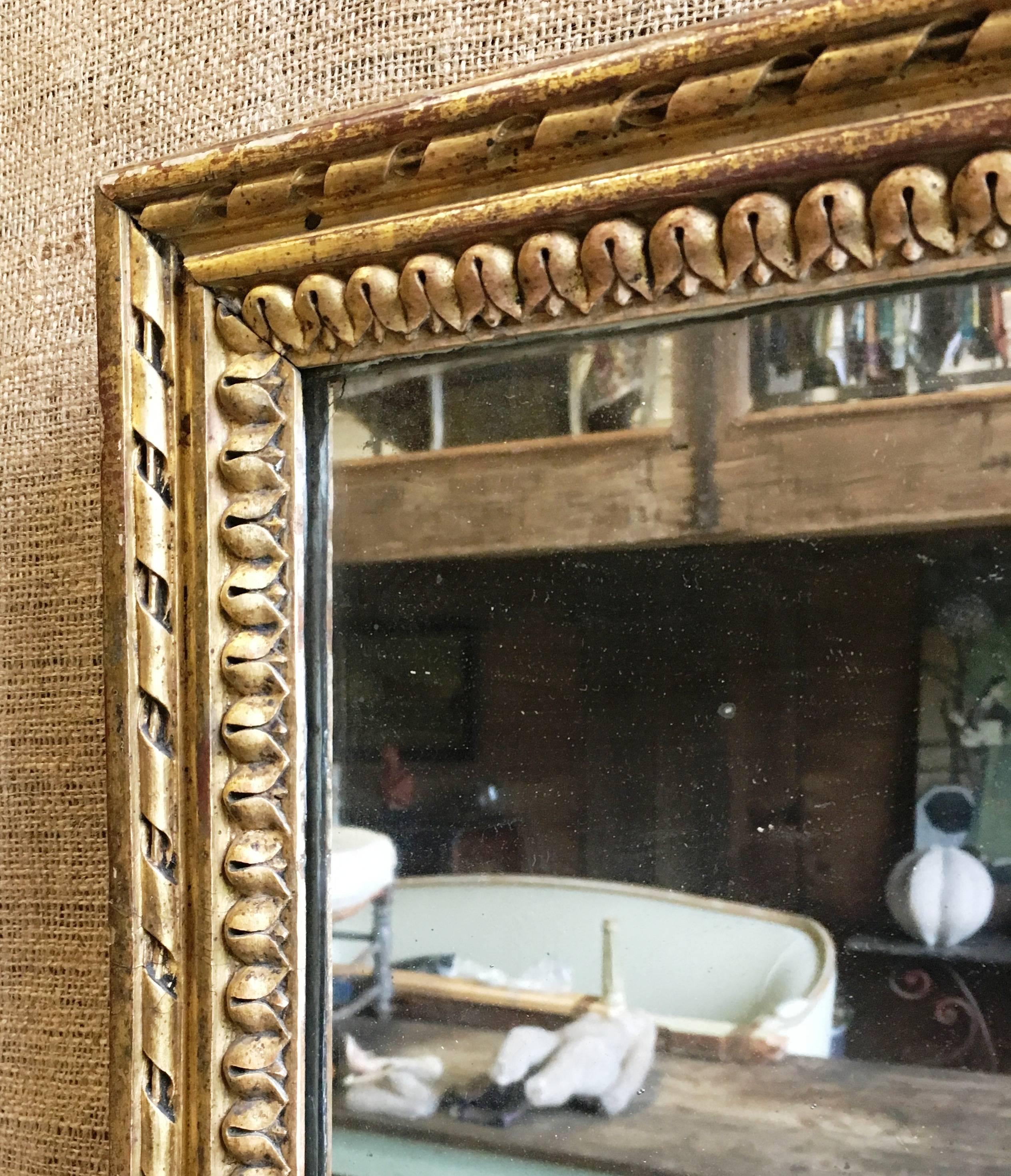 A Louis XVI period pier mirror, circa 1790. with a gilt-wood frame and retaining its original 2-part mercury glass plate and original wood back,