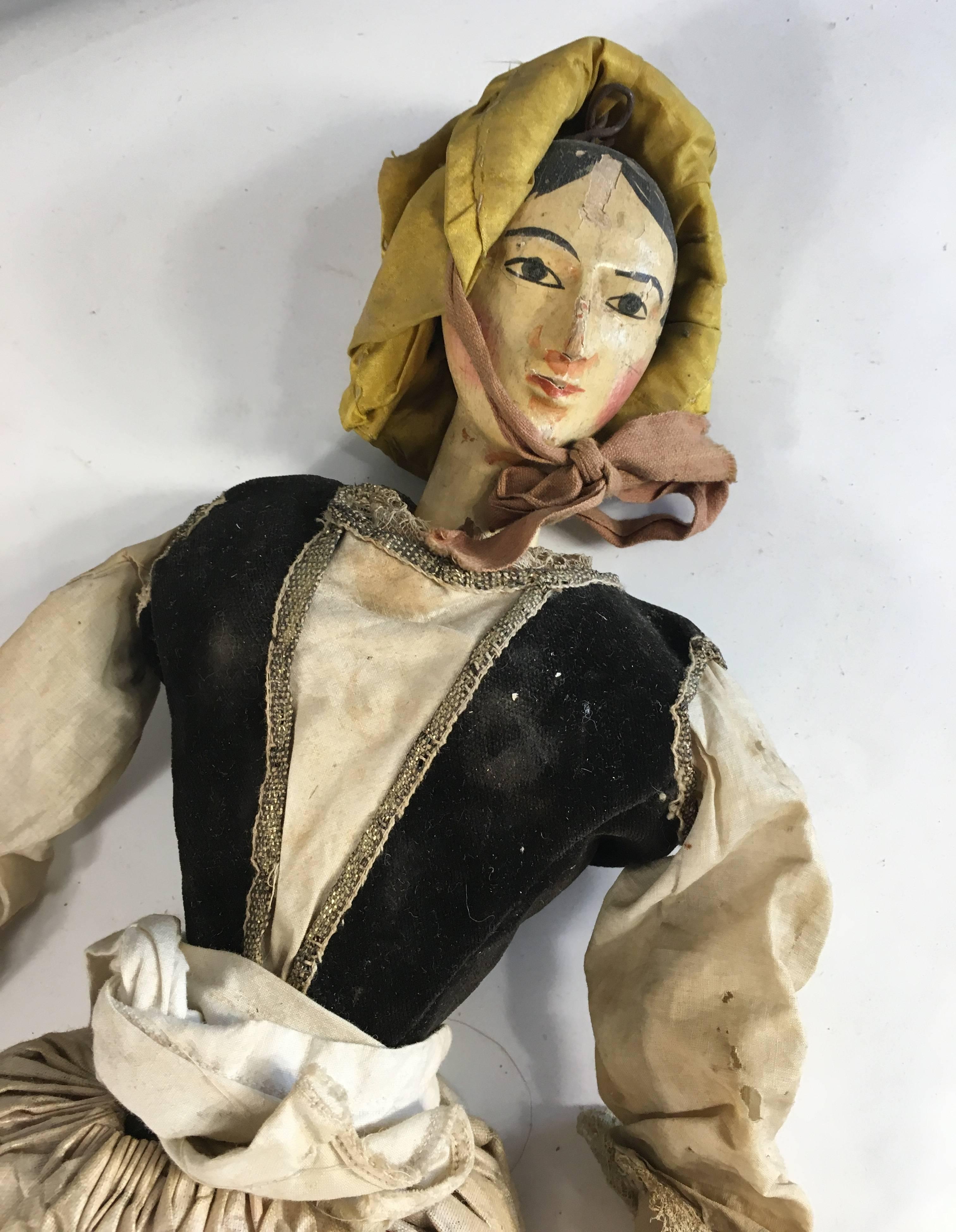 A 19th century, Italian marionette puppet of a peasant woman in carved and painted wood with period costume.
