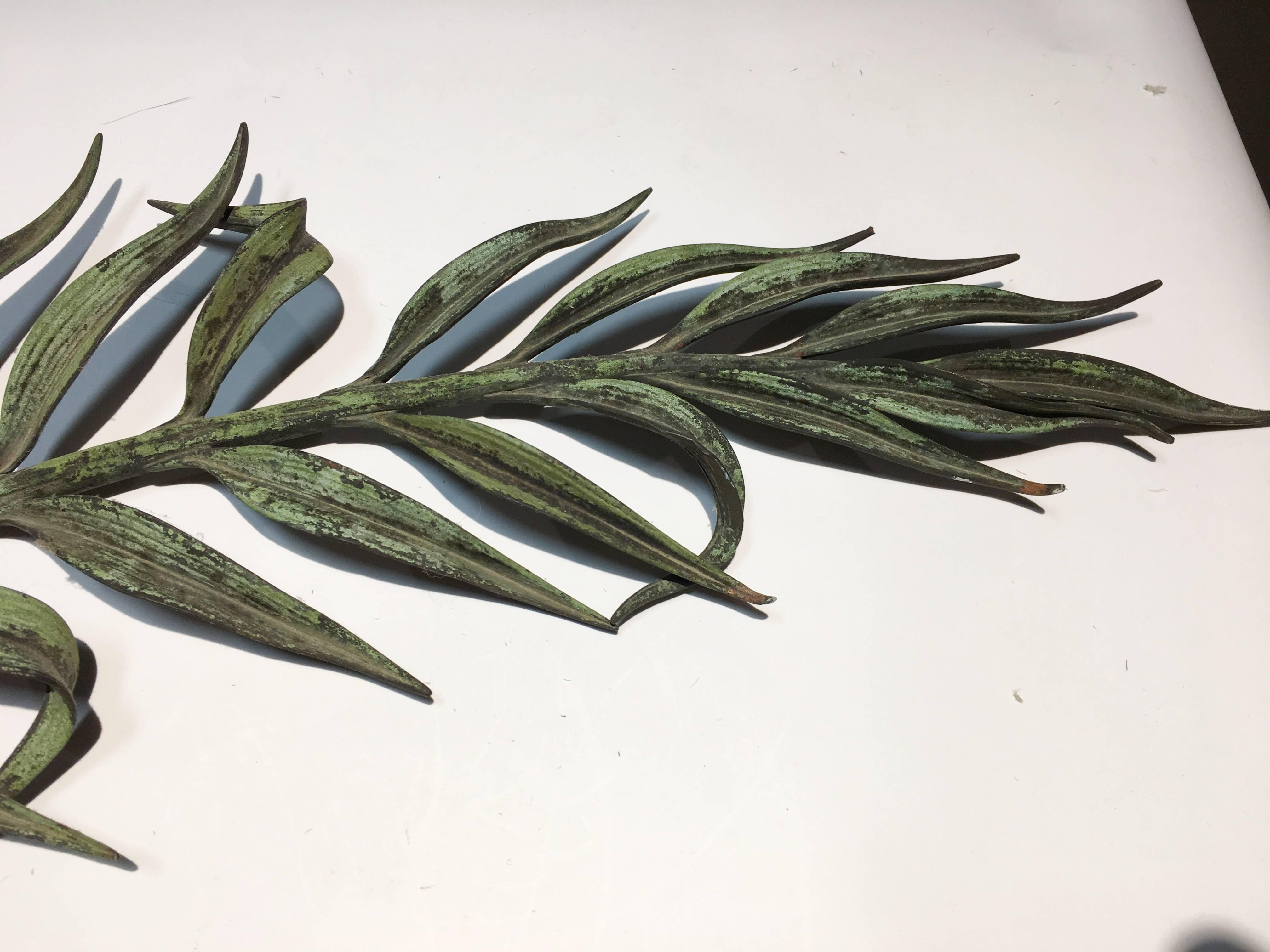 A Louis XVI cast bronze wall applique of olive branches with leaves tied at the base with a ribbon in a bow, early 19th century, nice verdigris patina.